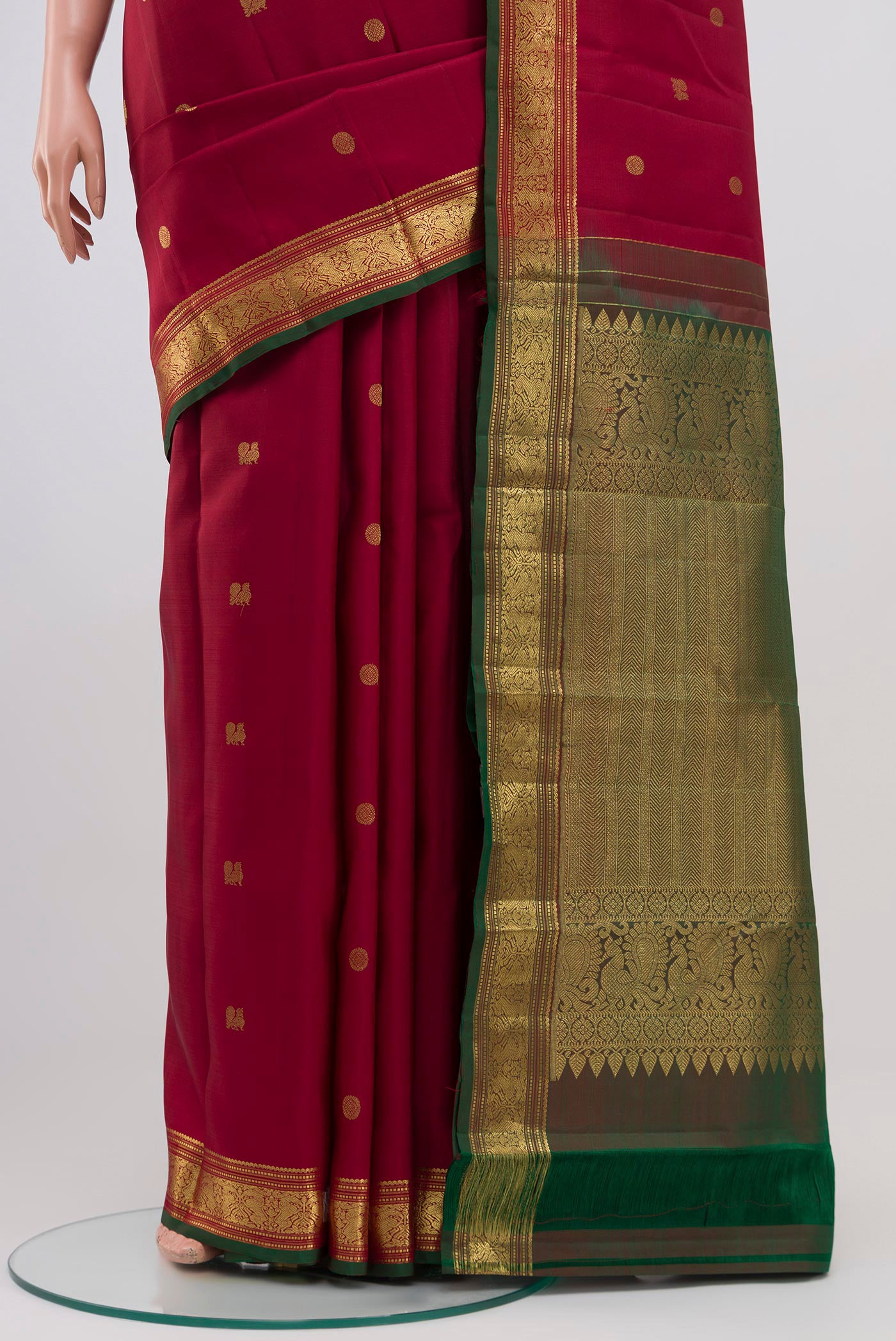 Pleats and pallu of Maroon Kanchipuram Saree with Zari Butta on the body and Zari Border. 