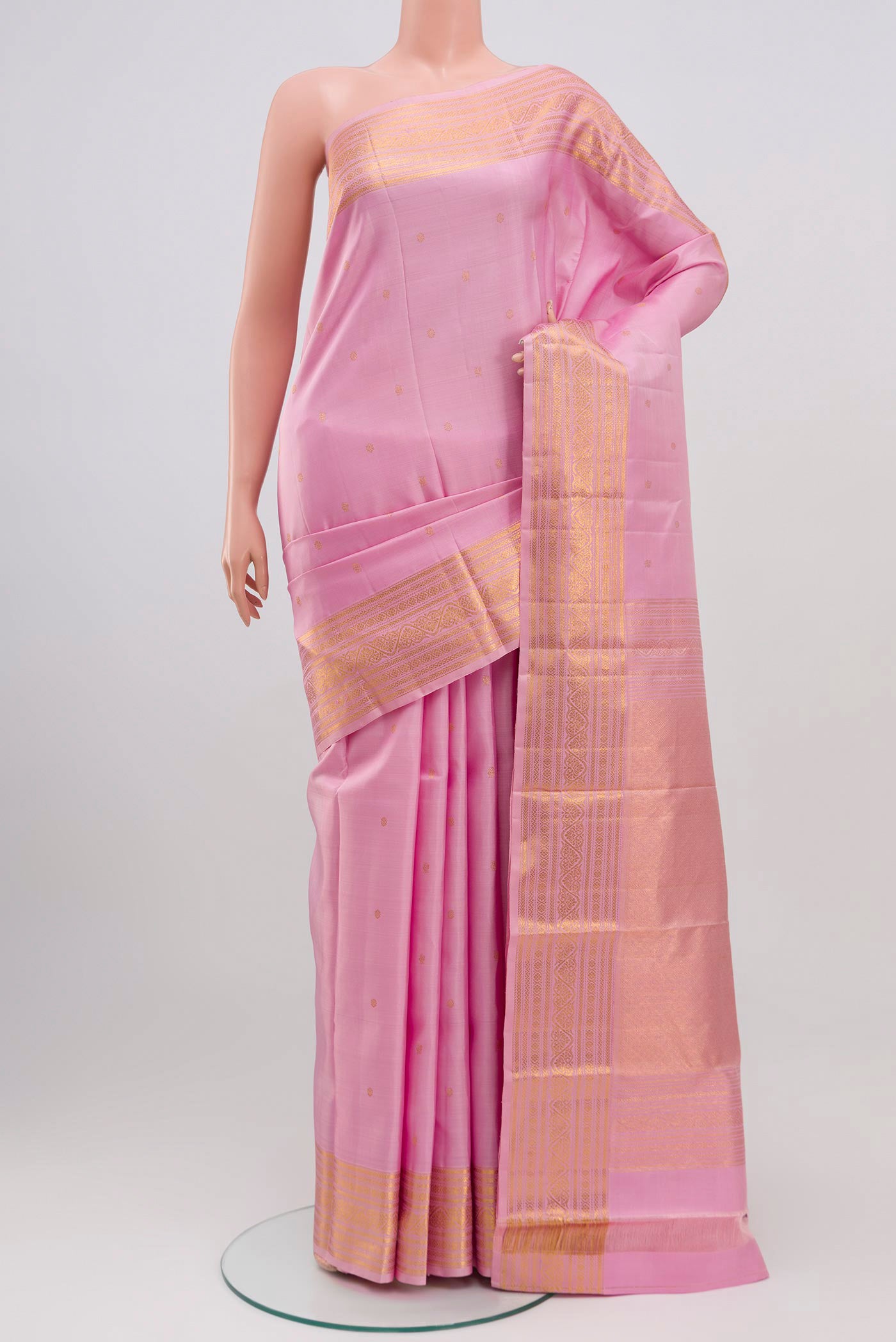 Pink Kanjivaram Saree with Zari Butta on the body and Zari Border.  displayed on a mannequin