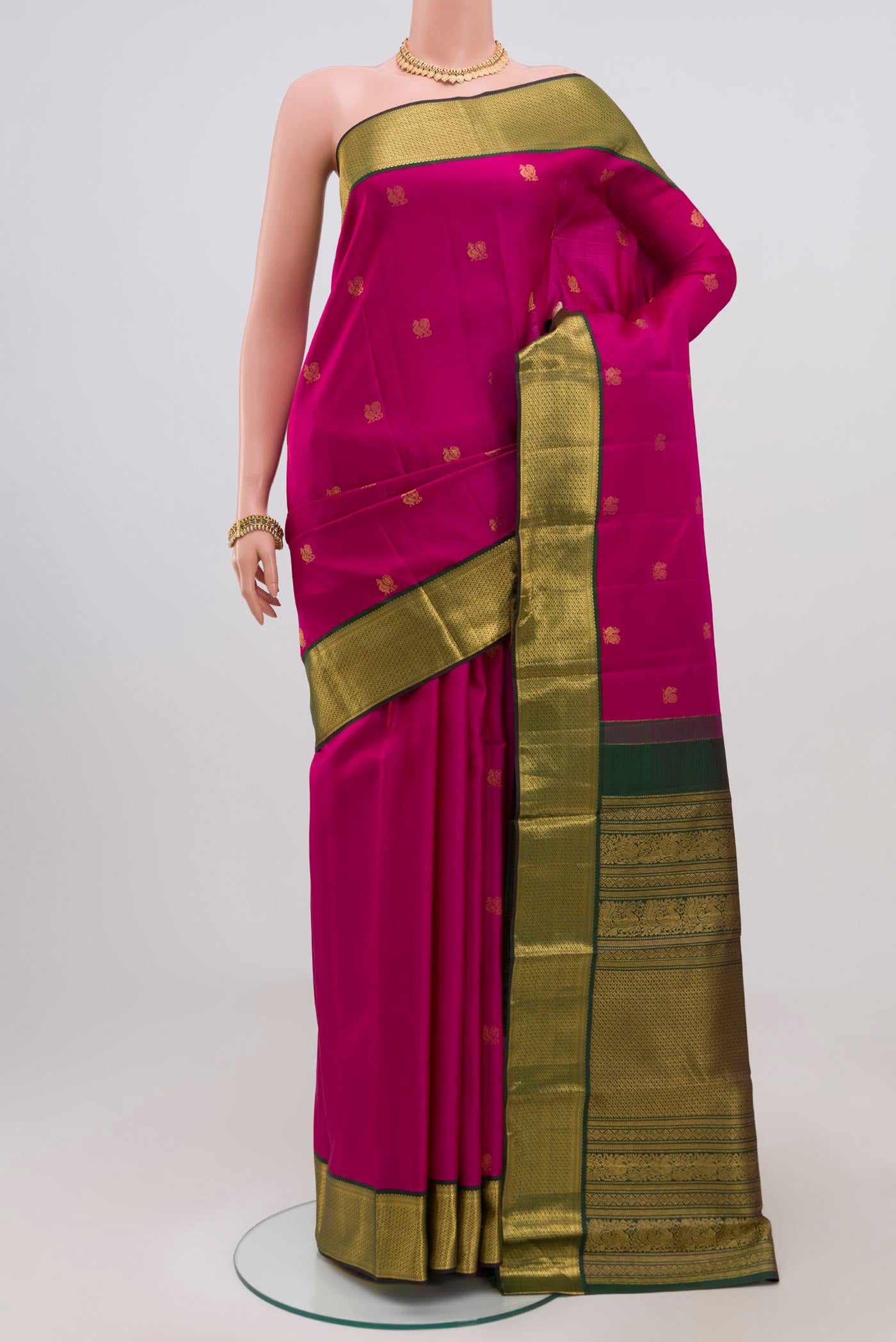 Dark Pink Kanchipuram Silk Saree with Zari Butta on the body and Zari Border.  displayed on a mannequin