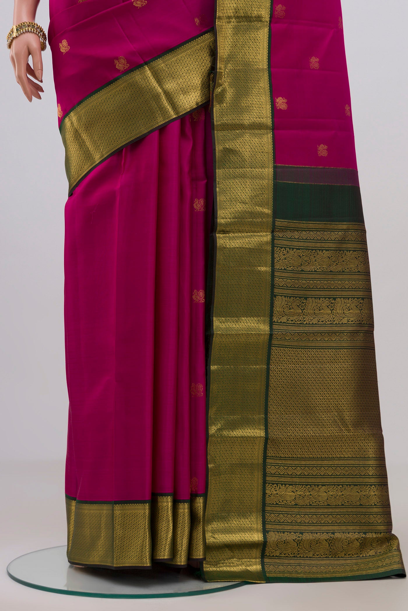 Pleats and pallu of Dark Pink Kanchipuram Silk Saree with Zari Butta on the body and Zari Border. 