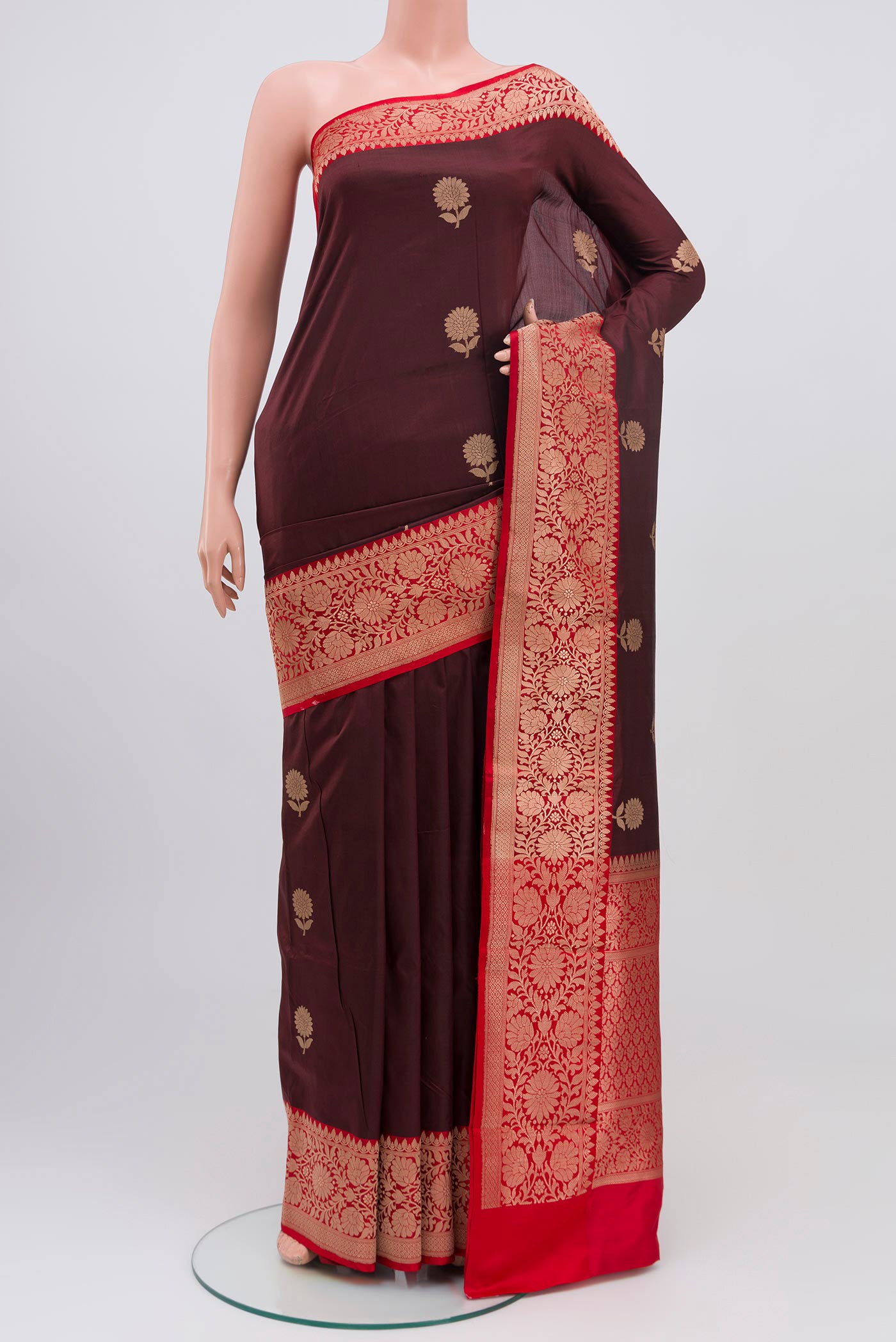Maroon Banarasi Katan Silk Saree with Zari Butta on the body and Zari Border.  displayed on a mannequin