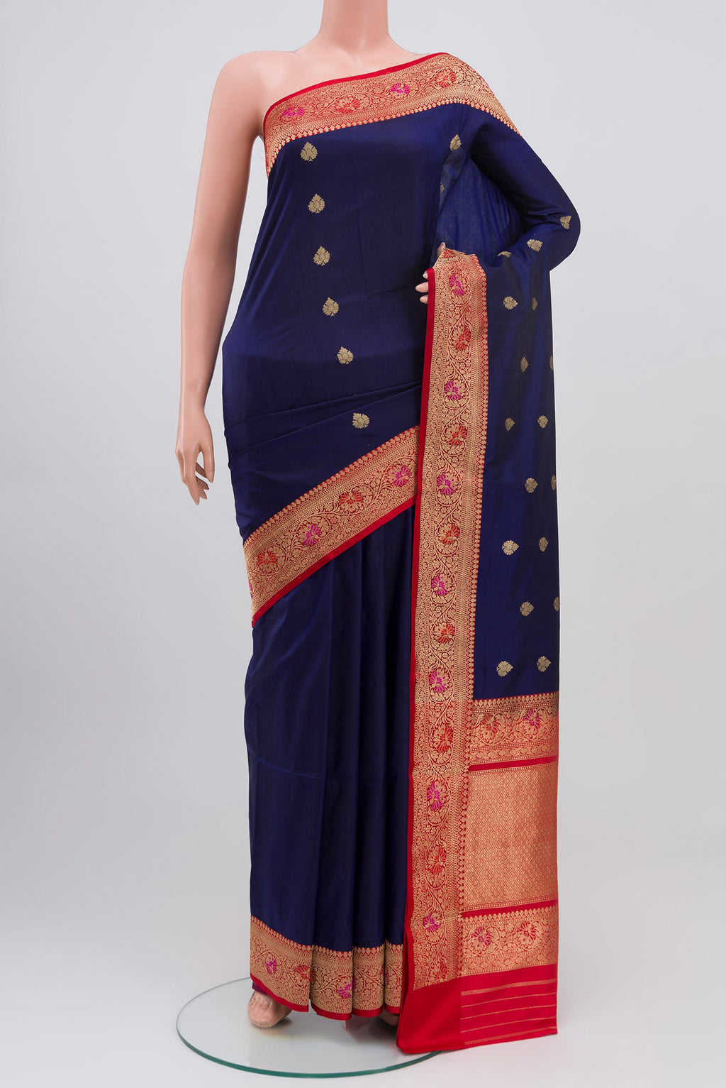 Blue Banarasi Katan Silk Saree with Zari Butta on the body and Zari Border.  displayed on a mannequin