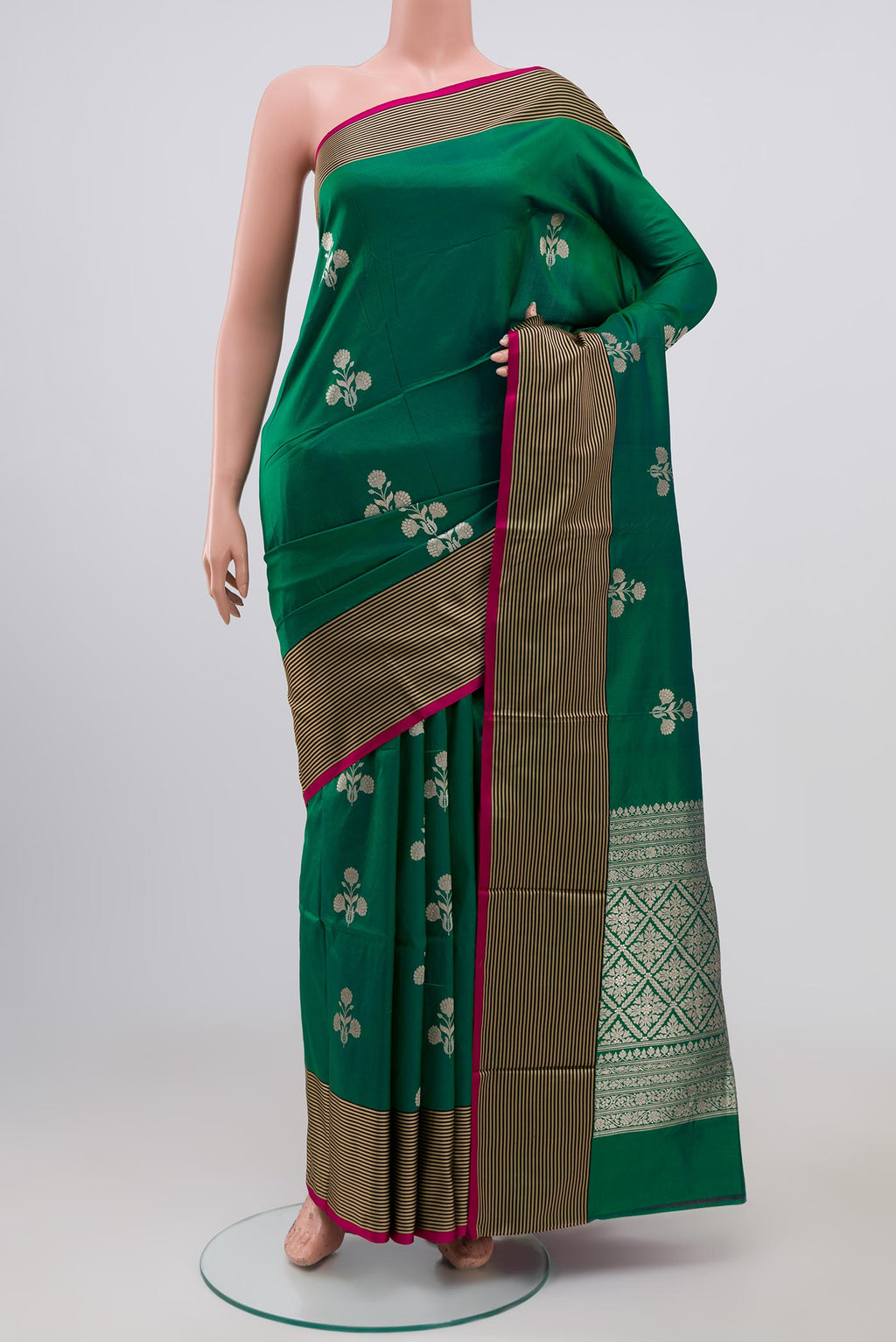 Green Banarasi Katan Silk Saree with Zari Butta on the body and Thin Zari Line.  displayed on a mannequin