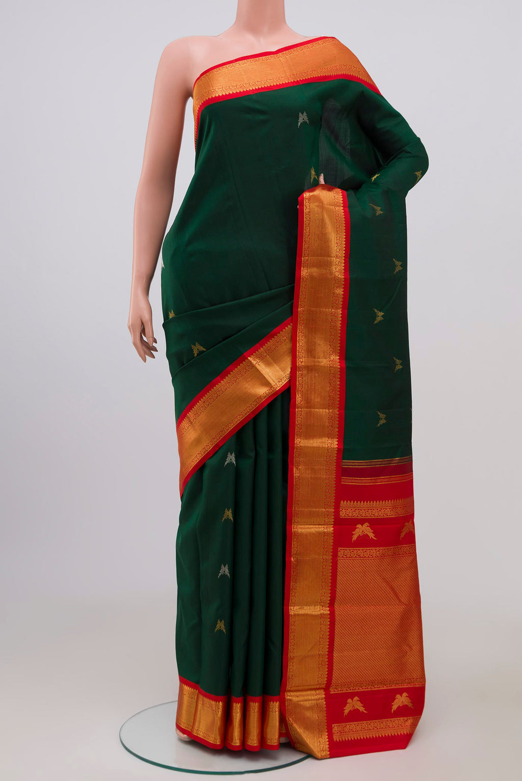 Pure Silk Pure Zari Bottle Green Kanjivaram Saree with Zari Butta on the body and Zari Border.  displayed on a mannequin