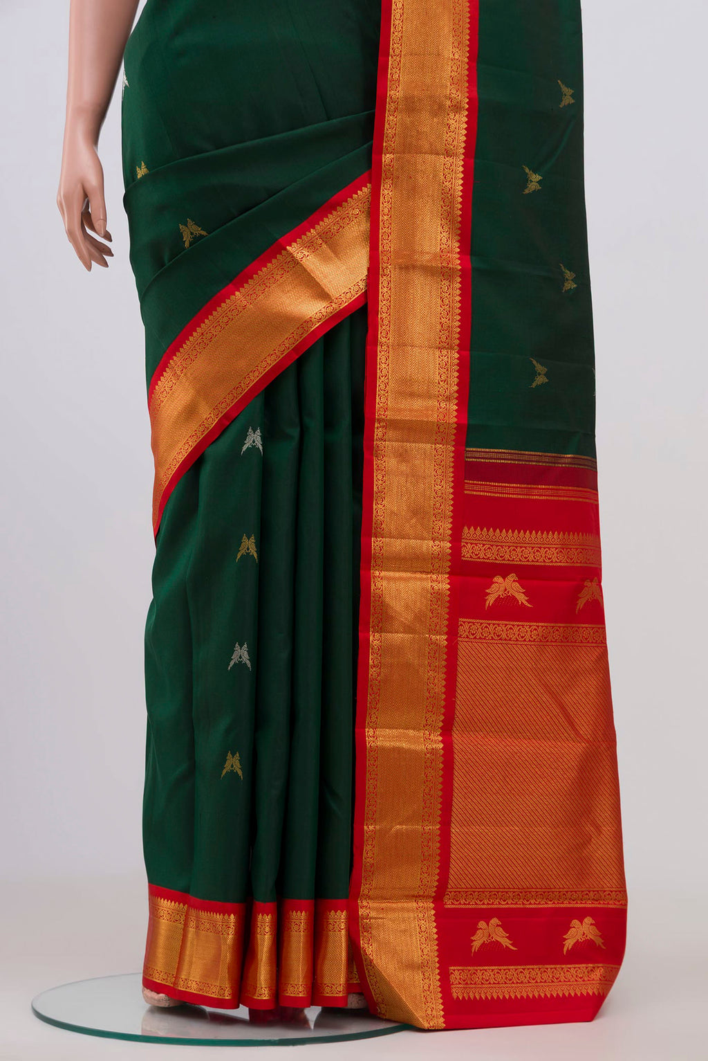 Pleats and pallu of Pure Silk Pure Zari Bottle Green Kanjivaram Saree with Zari Butta on the body and Zari Border. 