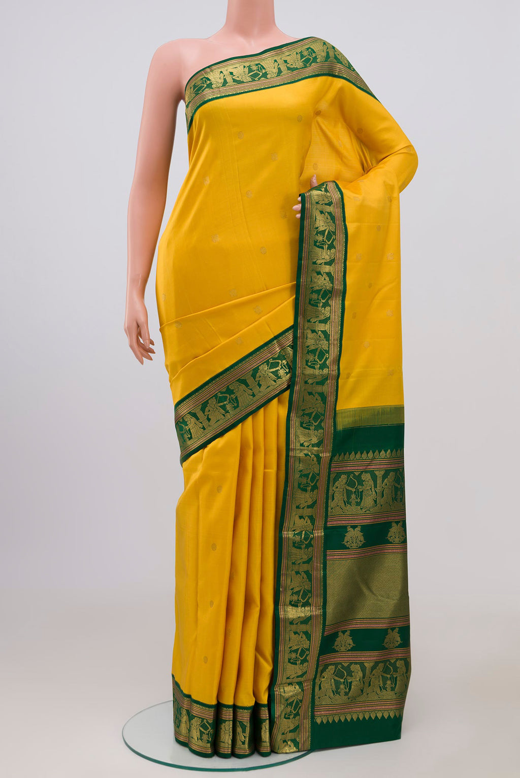 Pure Silk Pure Zari Yellow Kanjivaram Saree with Zari Butta on the body and Zari Border.  displayed on a mannequin