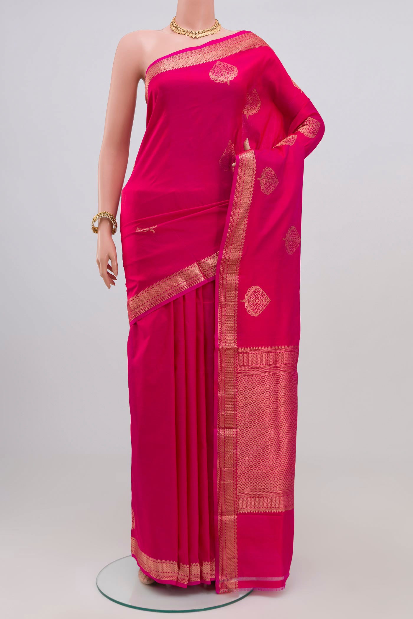 Pink Banarasi Katan Silk Saree with Zari Butta on the body and Zari Border.  displayed on a mannequin