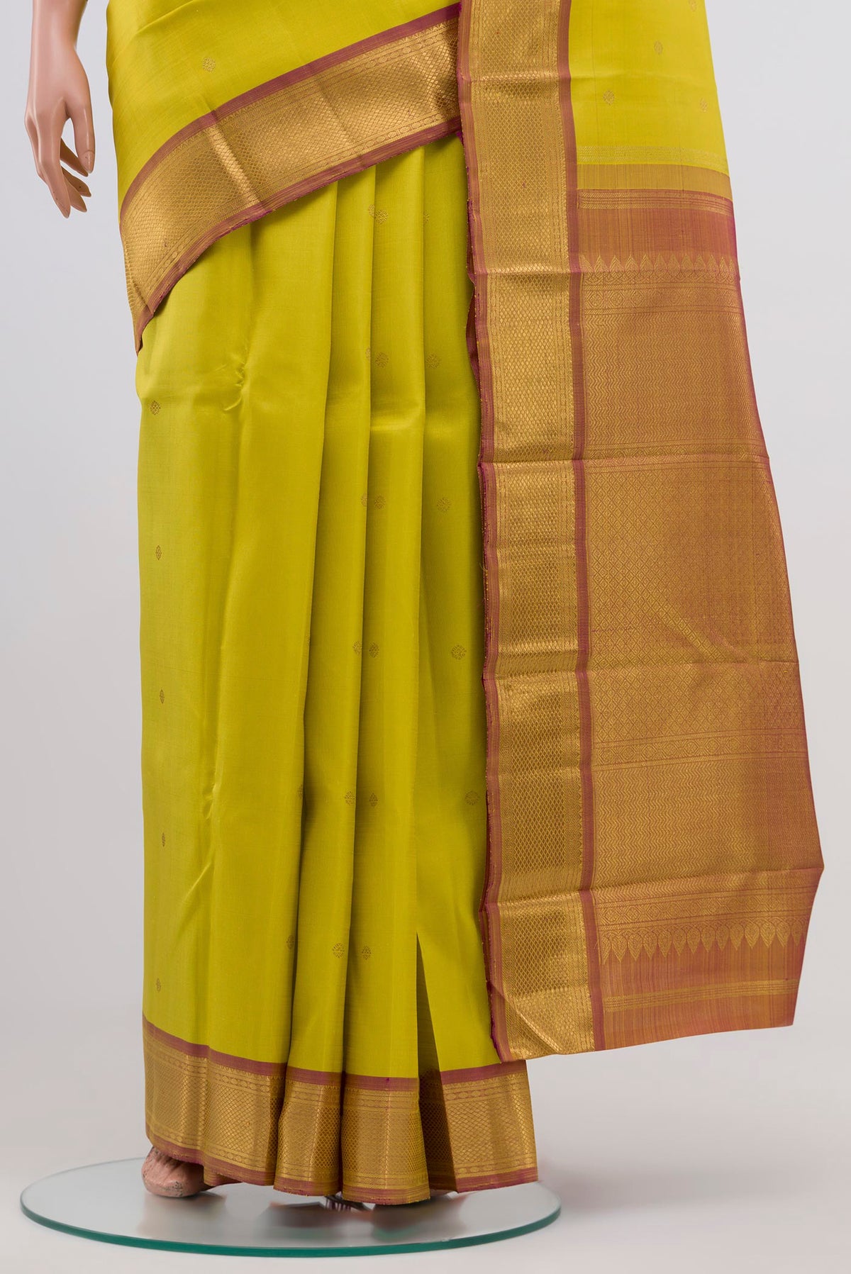 Pleats and pallu of Pure Silk Pure Zari Lemon Yellow Kanjivaram Saree with Zari Butta on the body and Zari Border. 