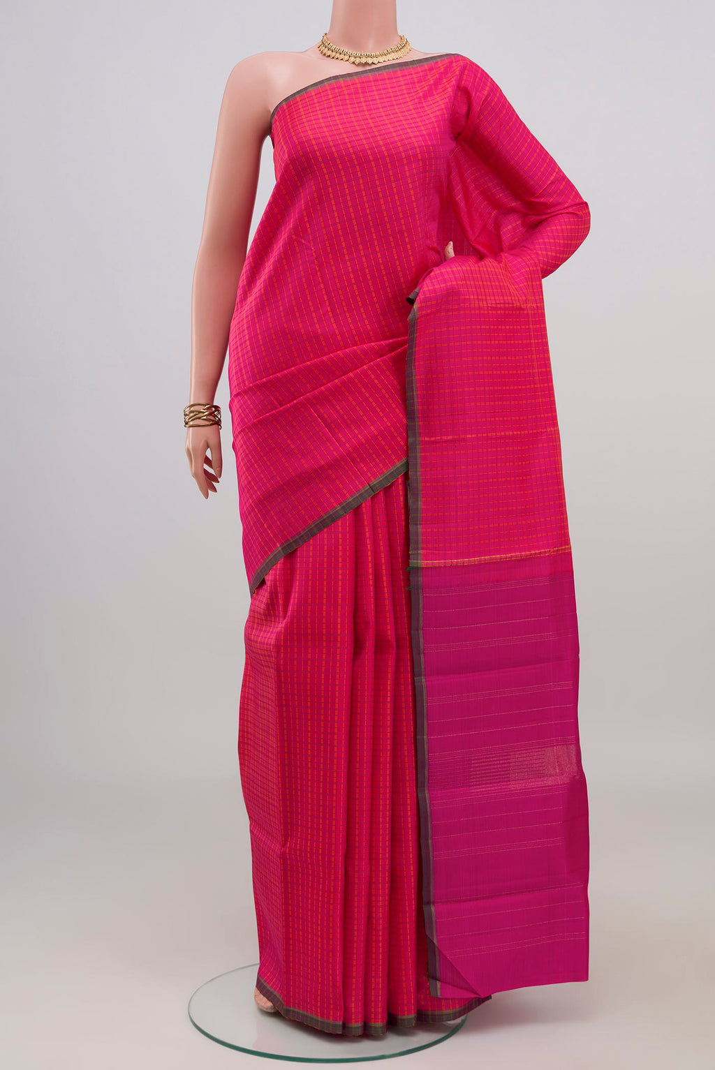 Pink Kanjivaram Silk Saree with Checked design on the body and Without Border.  displayed on a mannequin