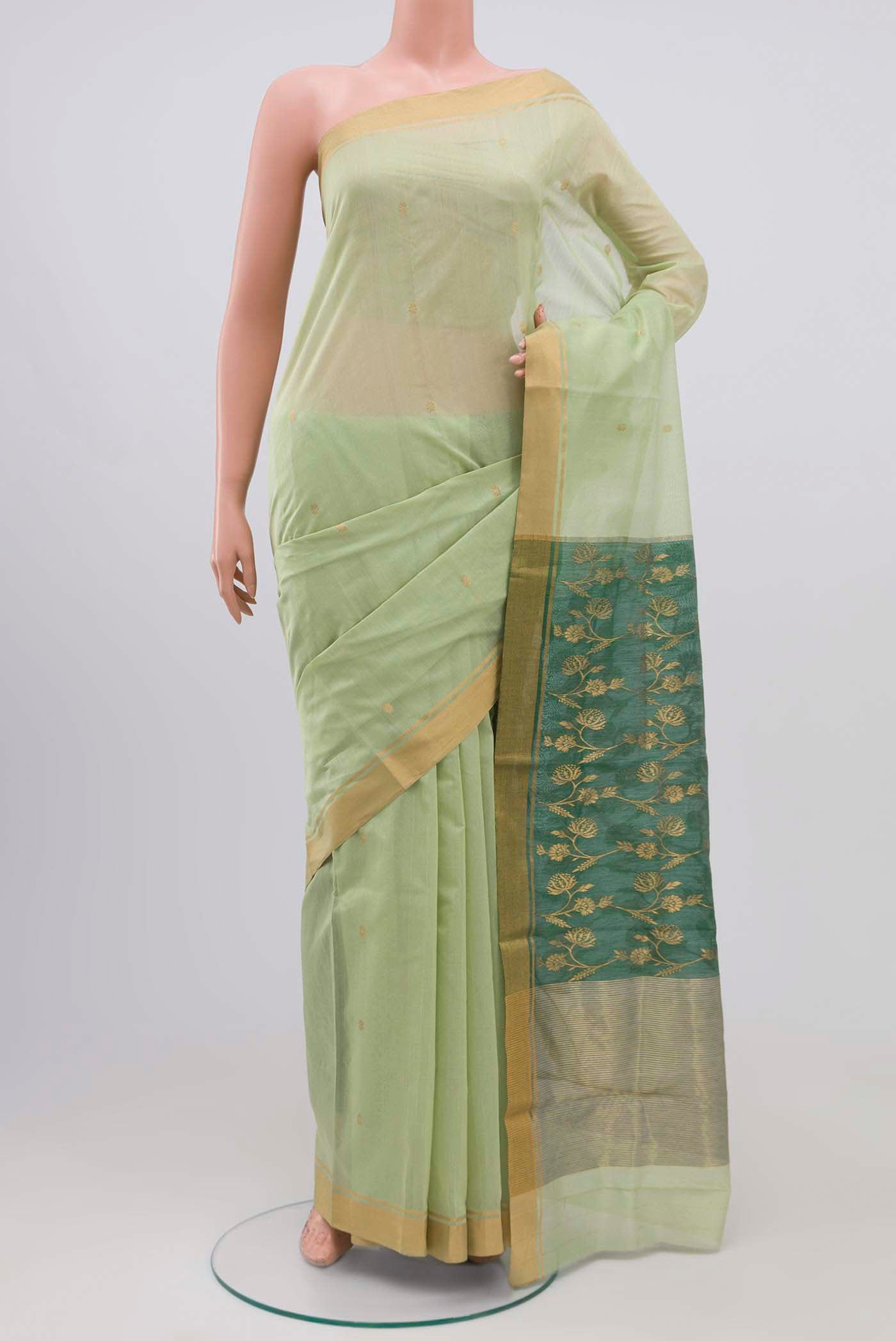 Pista Green Chanderi Silk Cotton Saree with Zari Butta on the body and Zari Border.  displayed on a mannequin