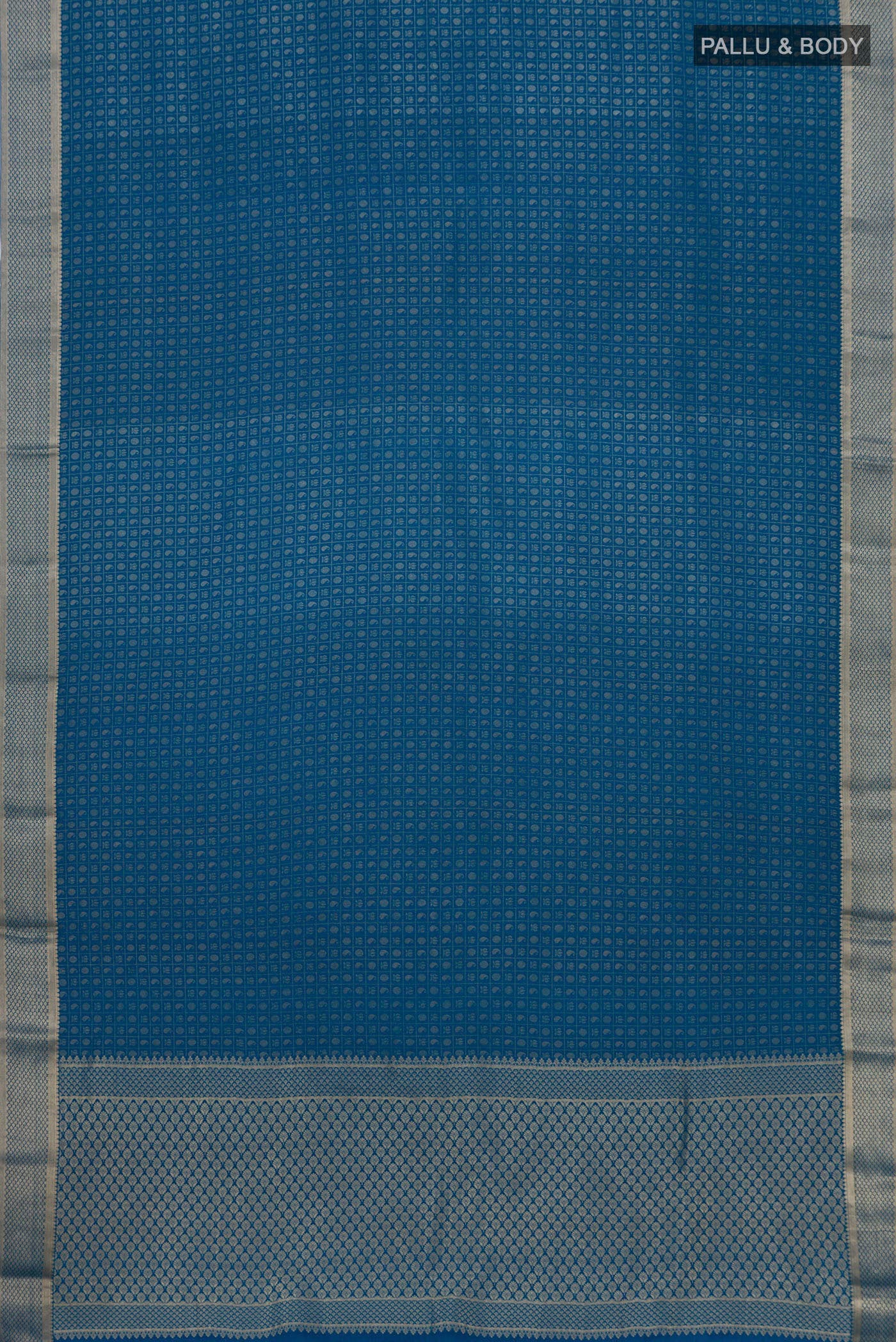 Flat view of Blue Grey Mysore Crepe Saree with Zari Butta on the body and Zari Border. 