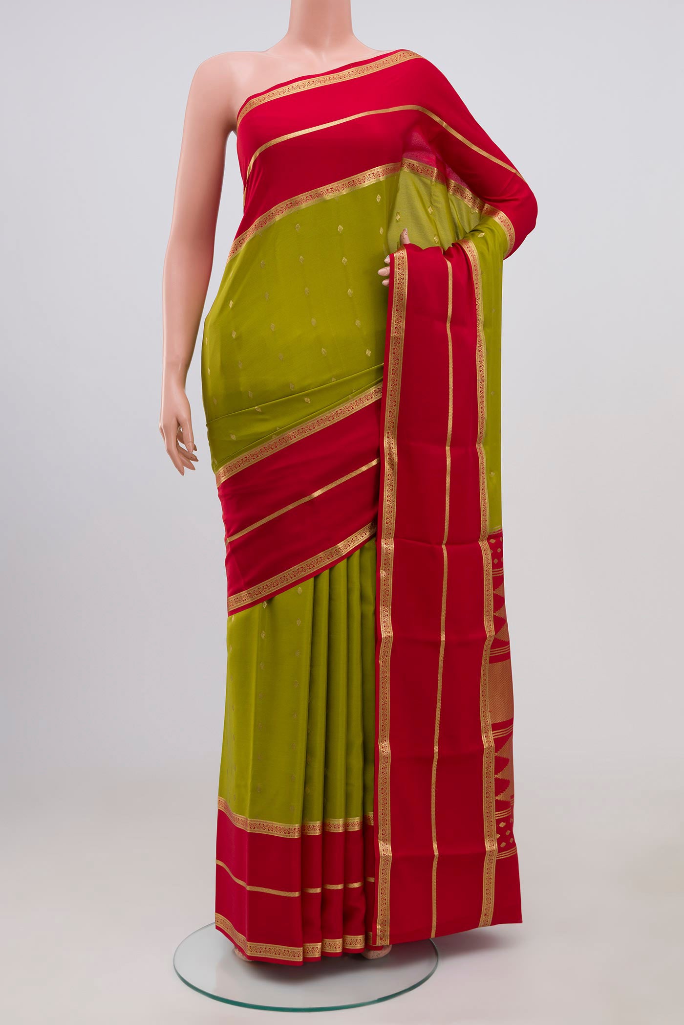 Olive Green Crepe Saree with Zari Butta on the body and Zari Border.  displayed on a mannequin