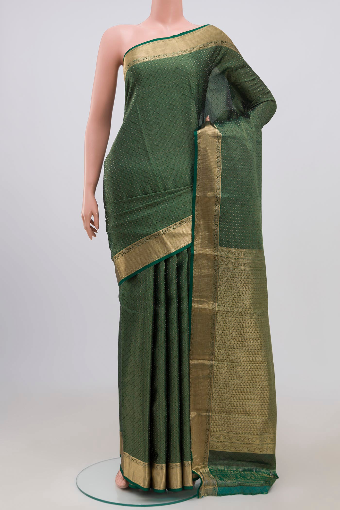 Green Kanjivaram Saree with Zari Butta on the body and Zari Border.  displayed on a mannequin