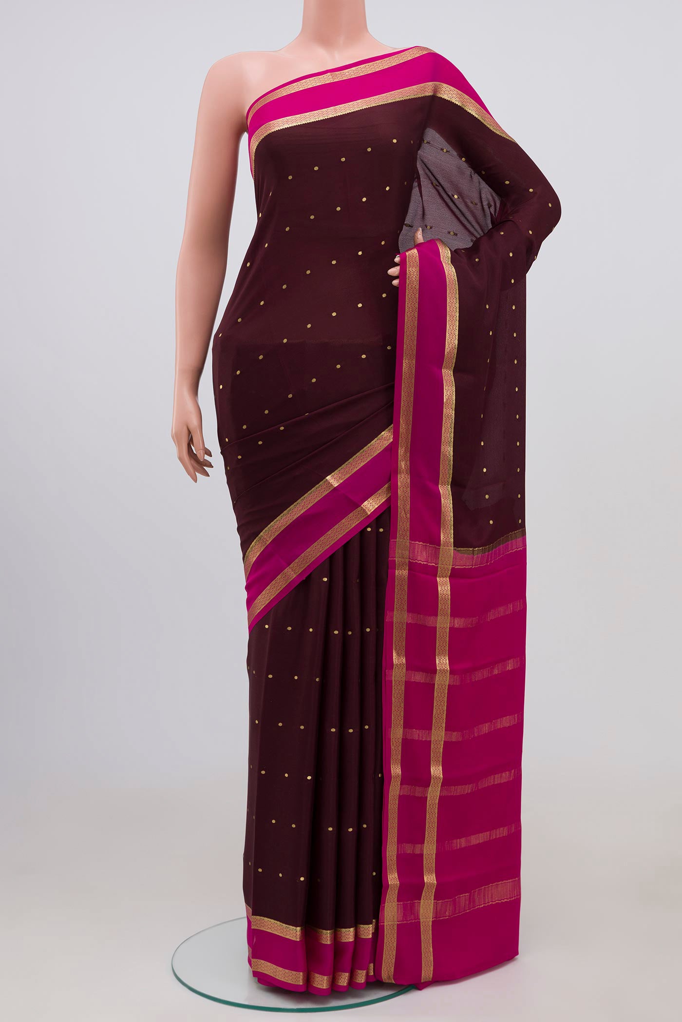 Brown Mysore Crepe Saree with Zari Butta on the body and Zari Border.  displayed on a mannequin