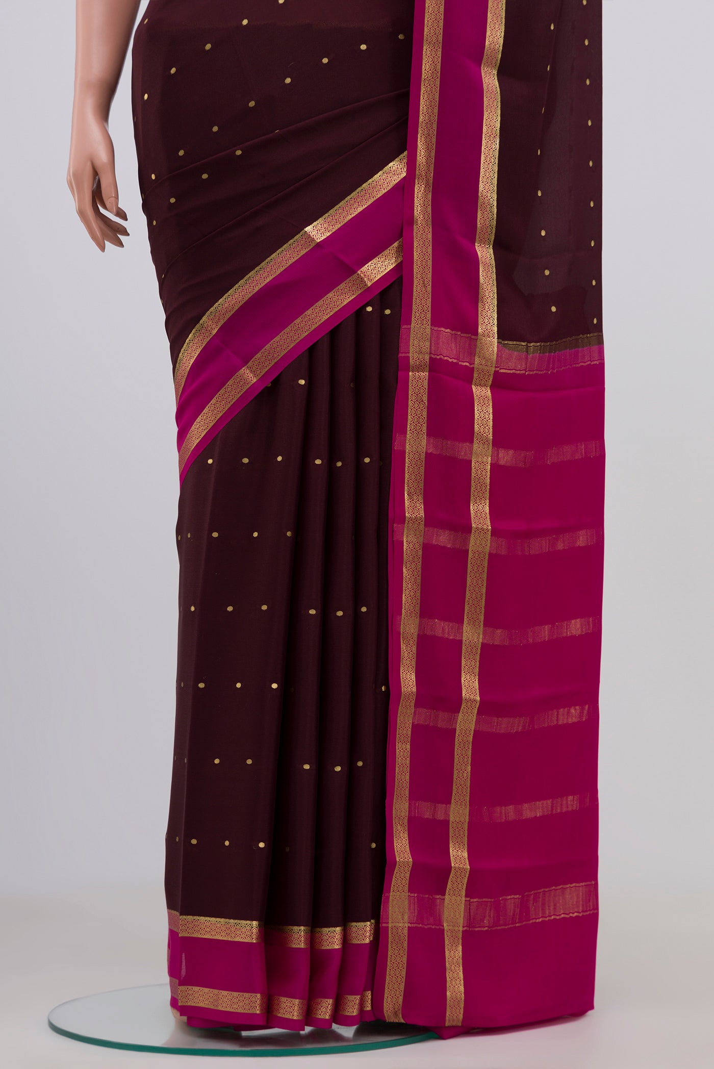 Pleats and pallu of Brown Mysore Crepe Saree with Zari Butta on the body and Zari Border. 