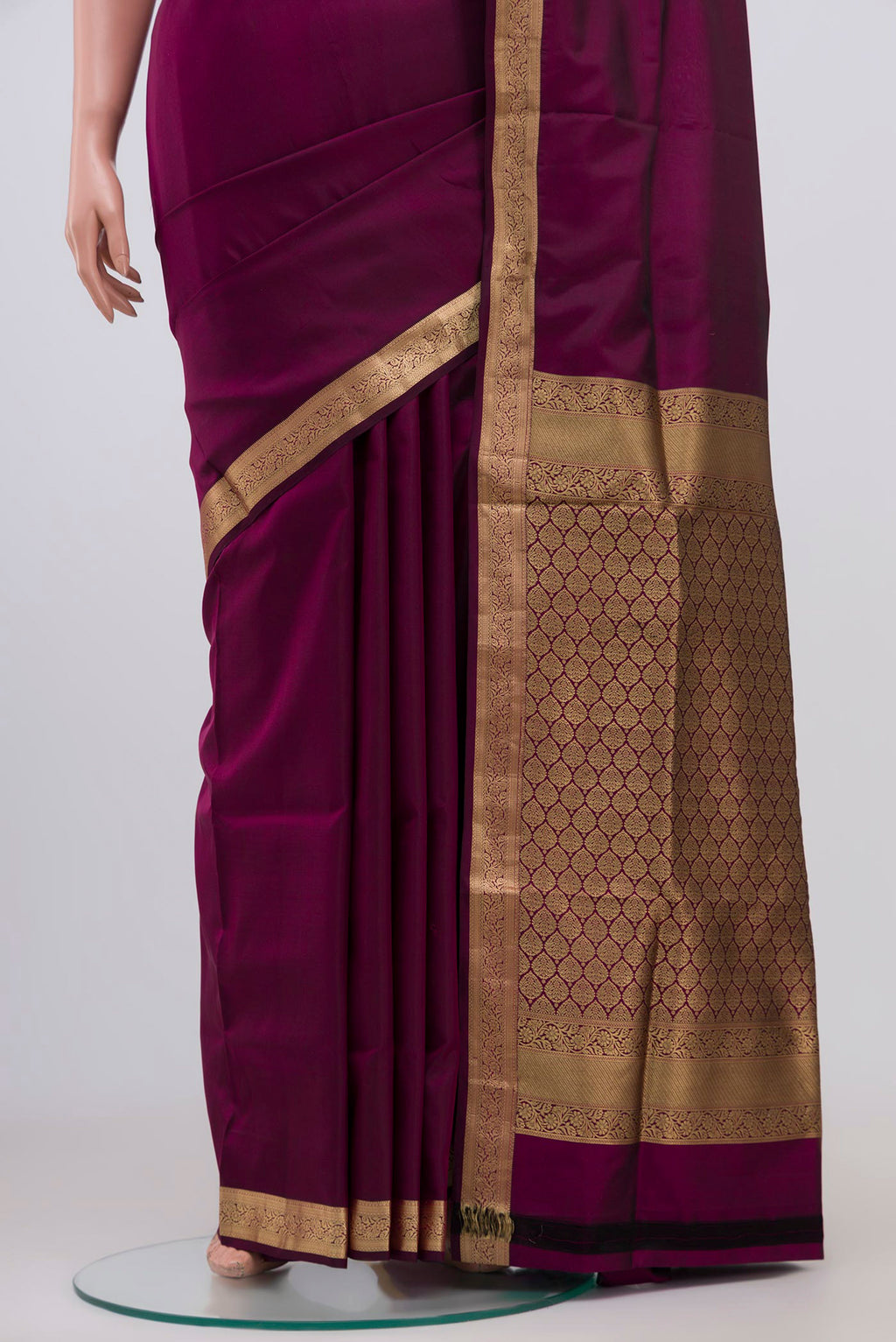 Pleats and pallu of Purple Soft Silk Saree with Plain Body and Zari Border. 