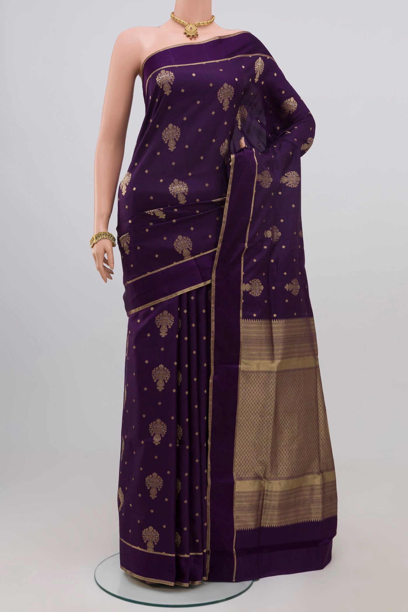 Purple Soft Silk Saree with Zari Butta on the body and Thin Zari Line.  displayed on a mannequin