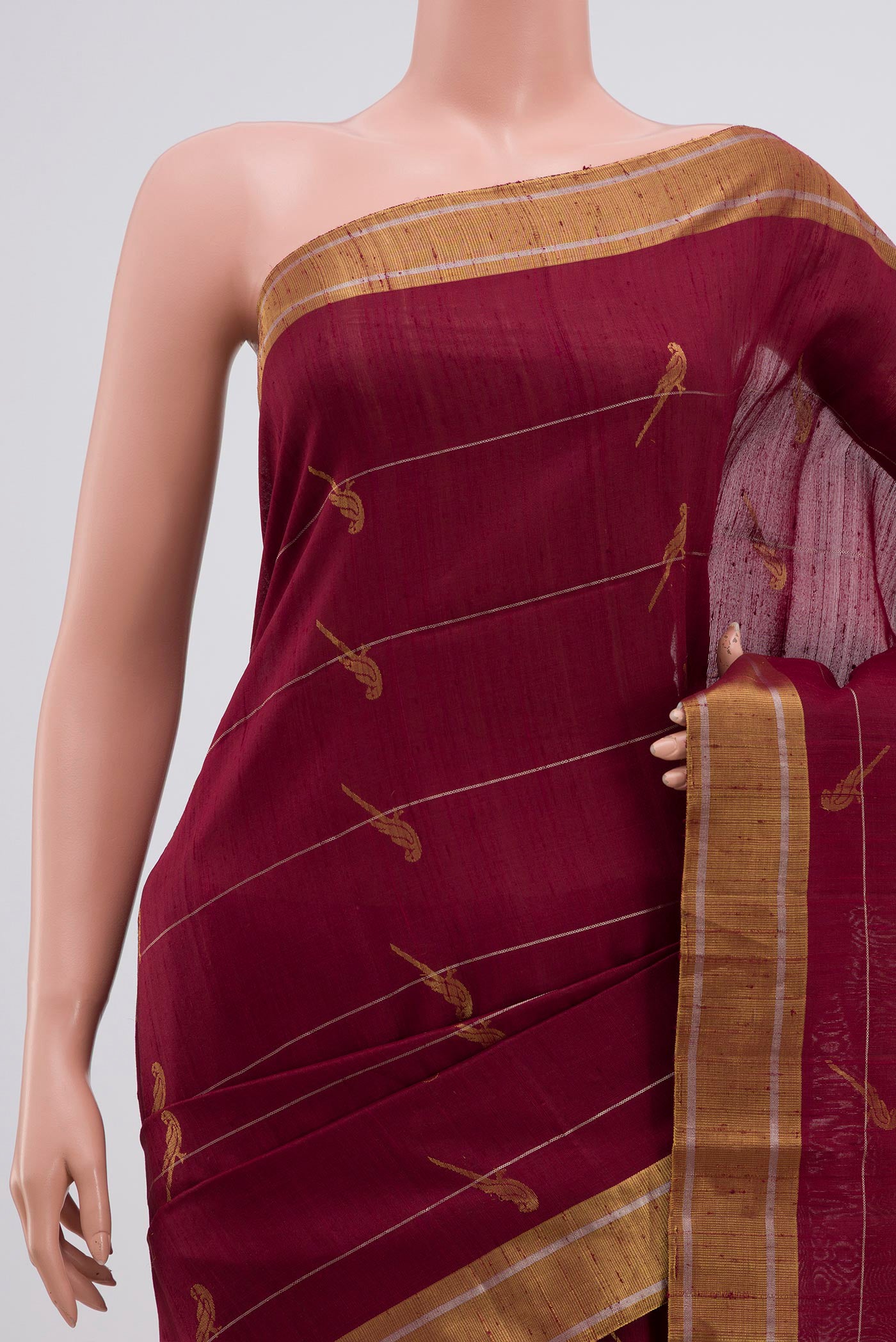 Border image of Maroon Soft Silk Saree with Zari Butta on the body and Zari Border. 