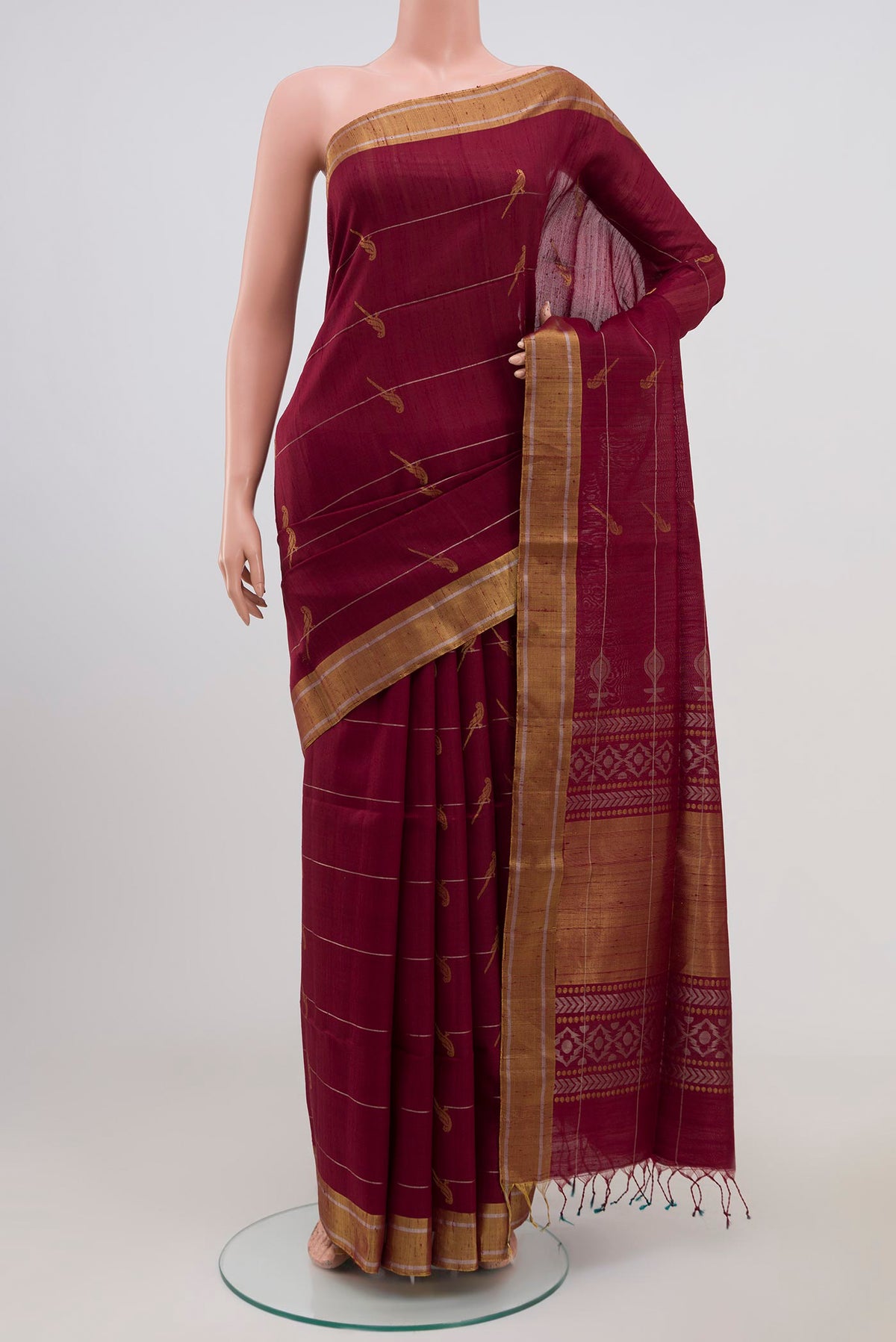Maroon Soft Silk Saree with Zari Butta on the body and Zari Border.  displayed on a mannequin