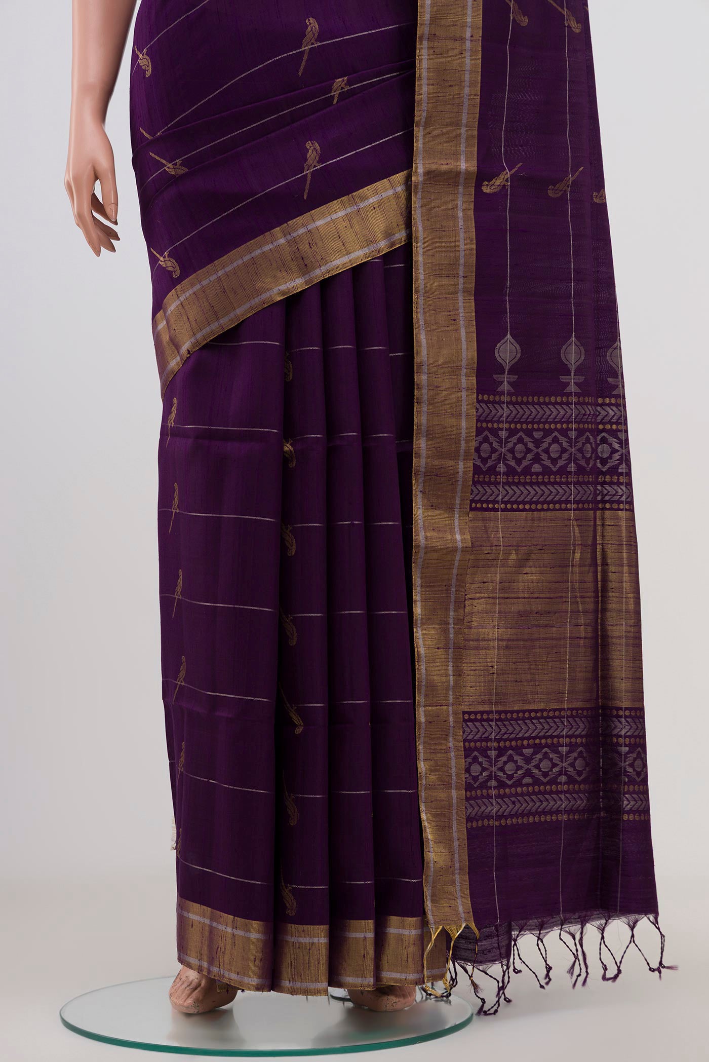 Pleats and pallu of Purple Soft Silk Saree with Zari Butta on the body and Zari Border. 