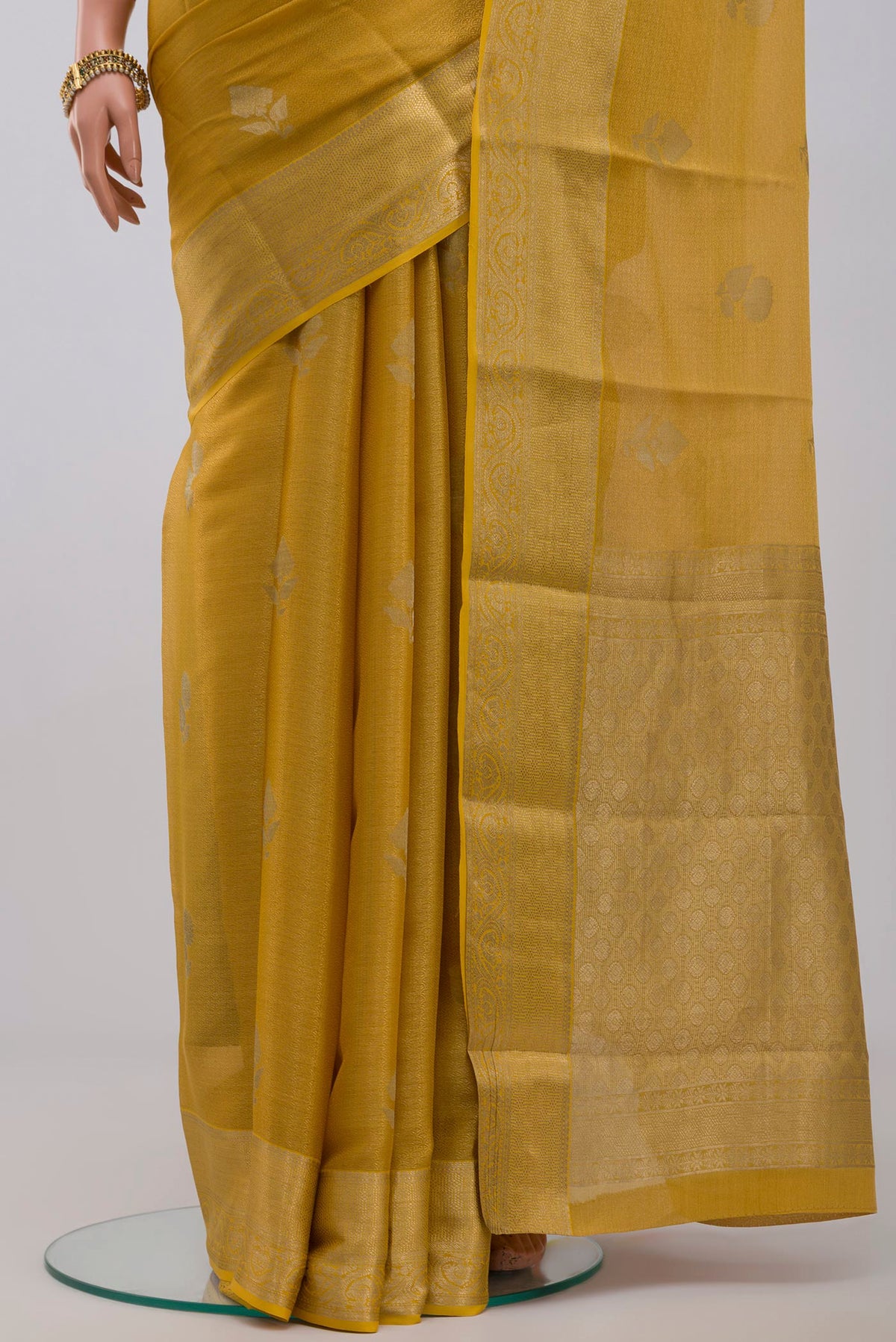 Pleats and pallu of Golden Georgette Saree with Zari Brocade on the body and Zari Border. 