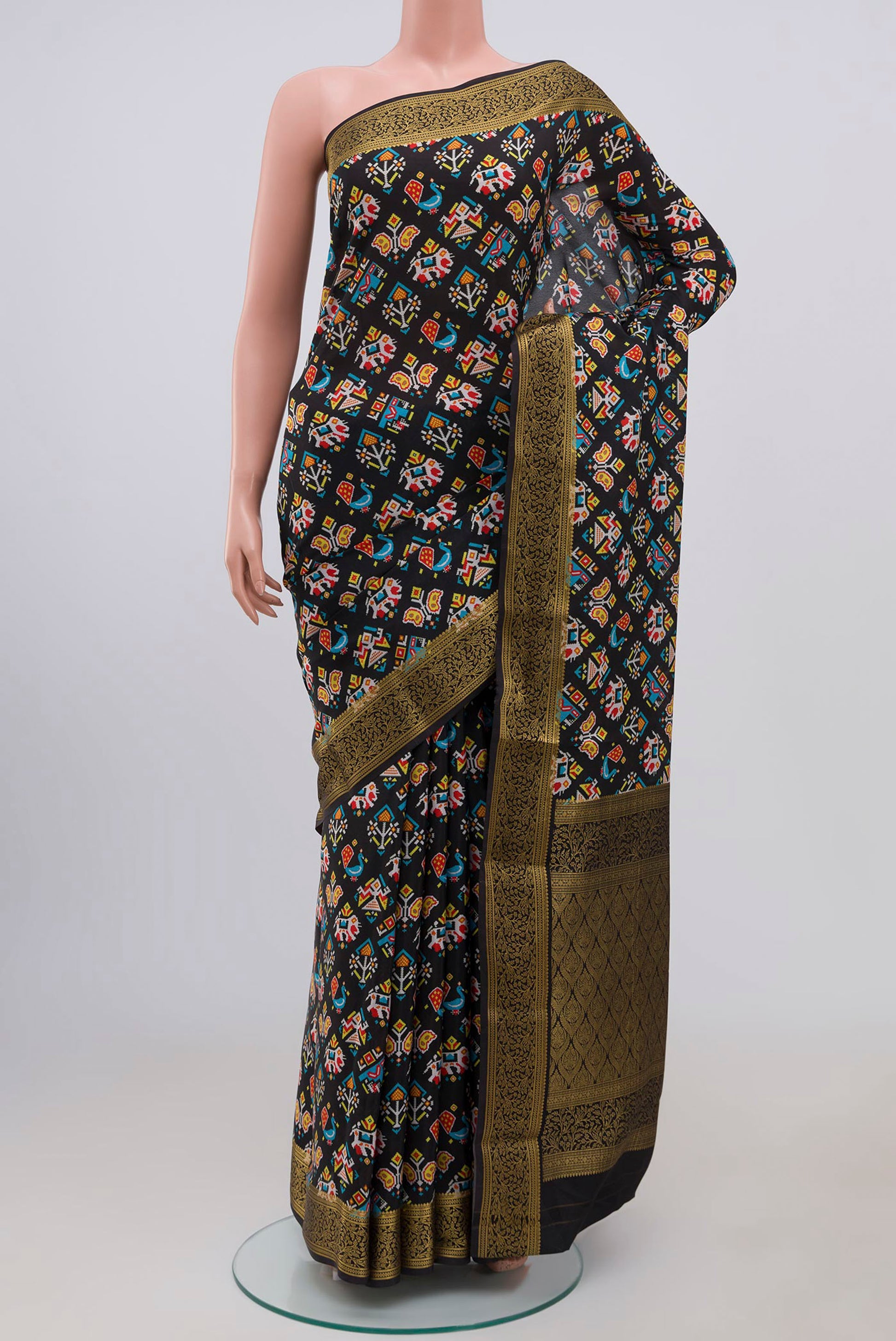Black Crepe Saree with Floral Print on the body and Zari Border.  displayed on a mannequin