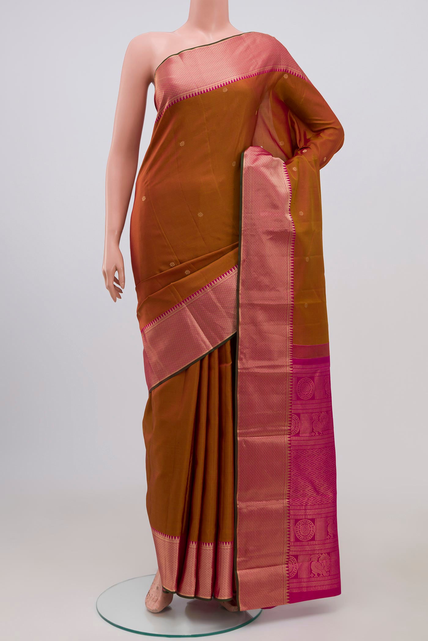 Mustard Kanchipuram Saree with Zari Butta on the body and Zari Border.  displayed on a mannequin