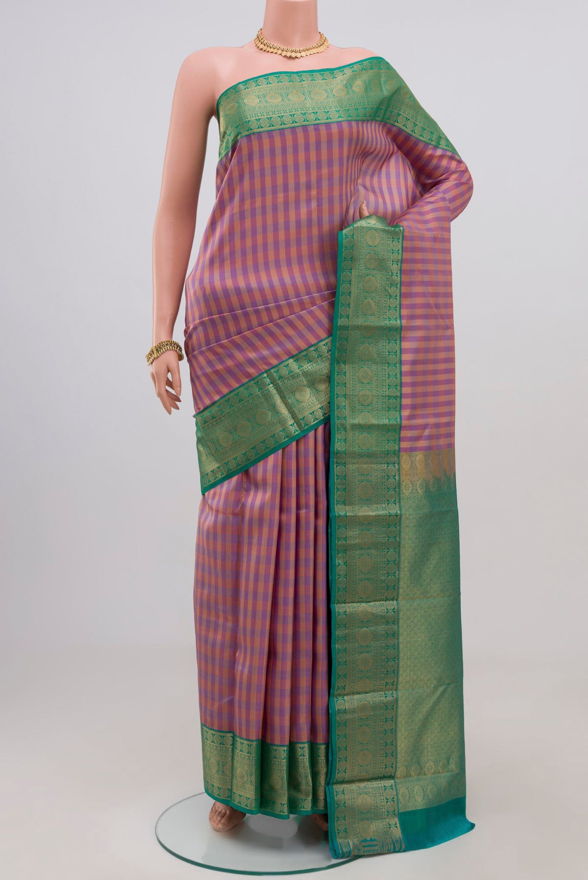 Multi Color Kanchipuram Silk Saree with Checked design on the body and Zari Border.  displayed on a mannequin