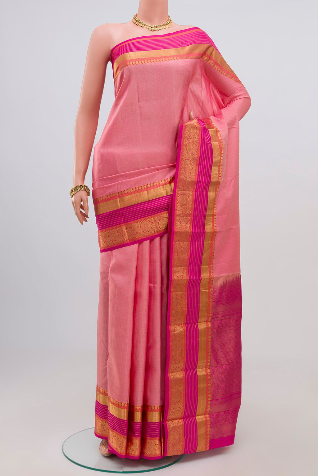 Pink Kanjivaram Saree with Stripes on the body and Zari Border.  displayed on a mannequin