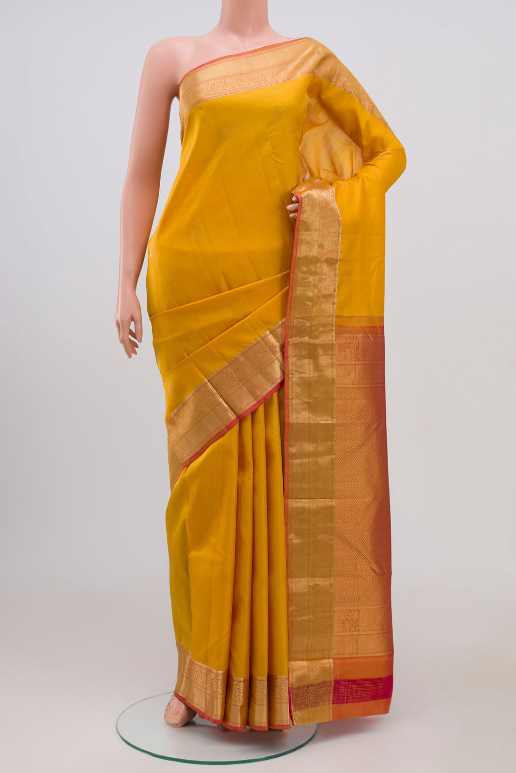 Yellow Kanchipuram Silk Saree with Zari Butta on the body and Zari Border.  displayed on a mannequin