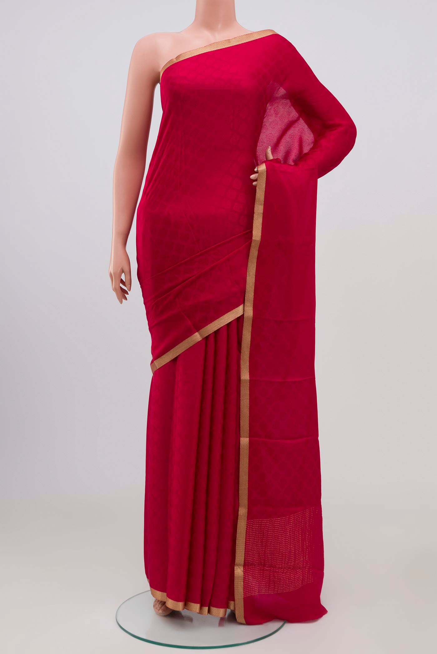 Pink Crepe Saree with Jacquard design on the body and Zari Border.  displayed on a mannequin