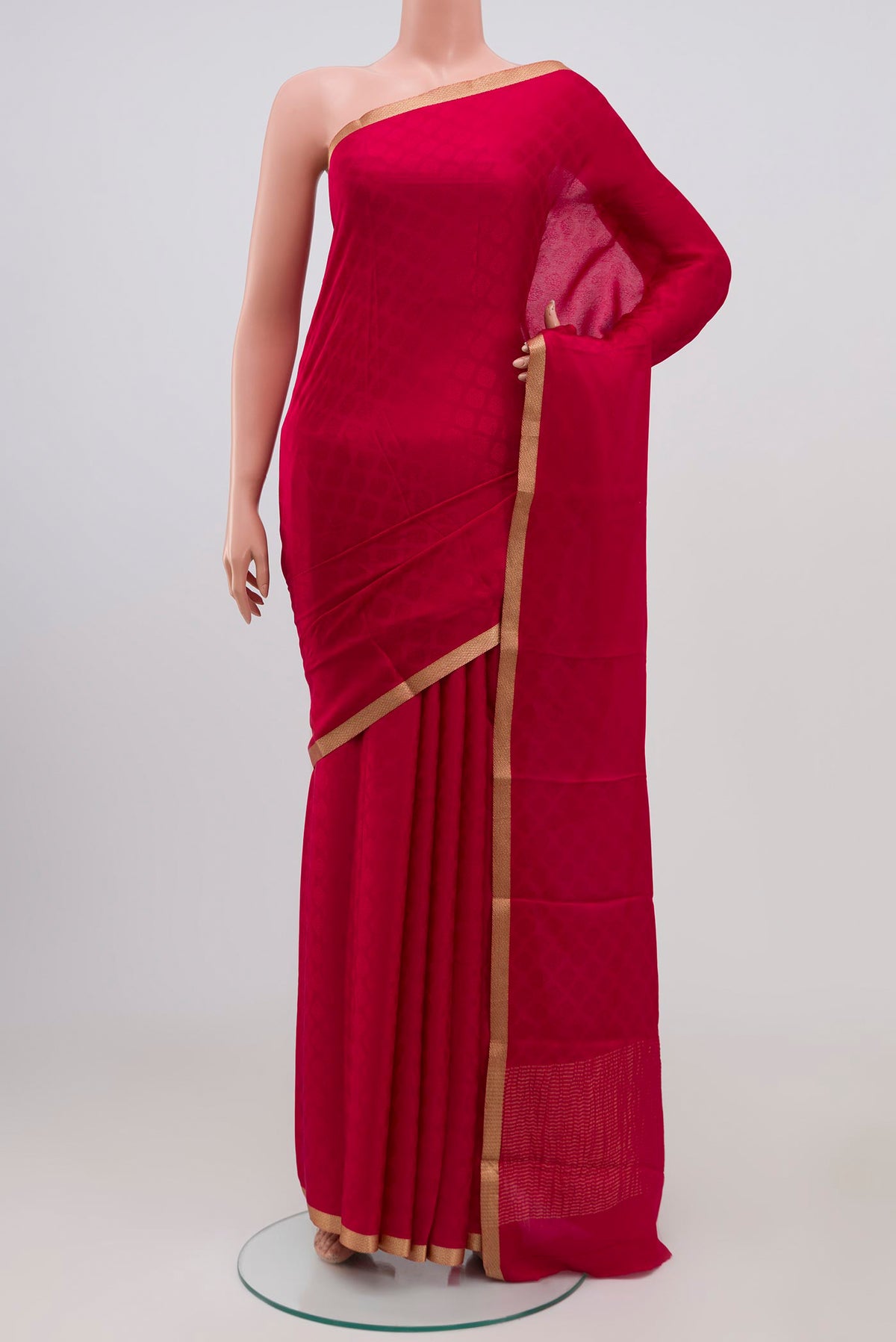Pink Crepe Saree with Jacquard design on the body and Zari Border.  displayed on a mannequin