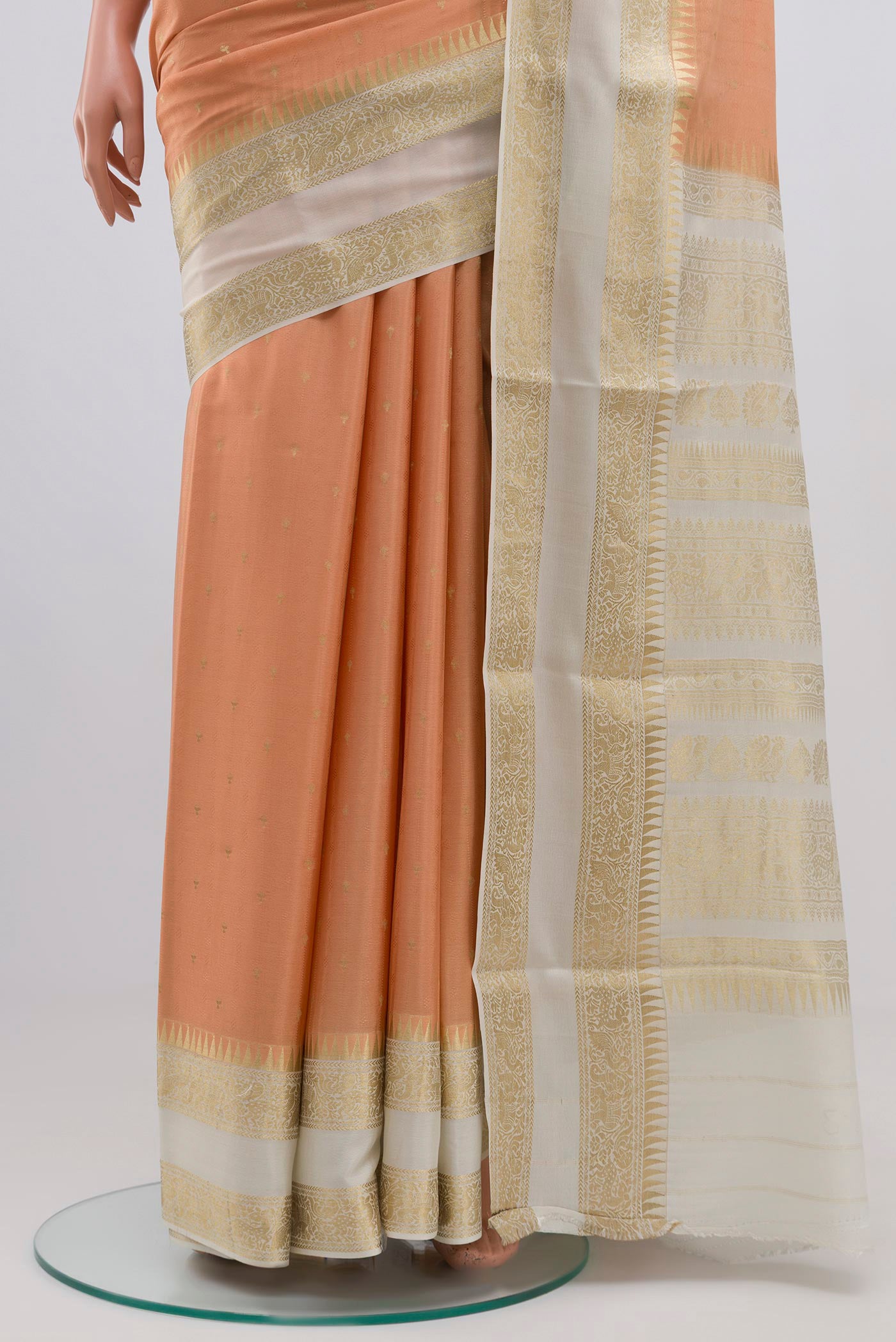Pleats and pallu of Peach Mysore Crepe Saree with Jacquard With Zari Butta on the body and Zari Border. 