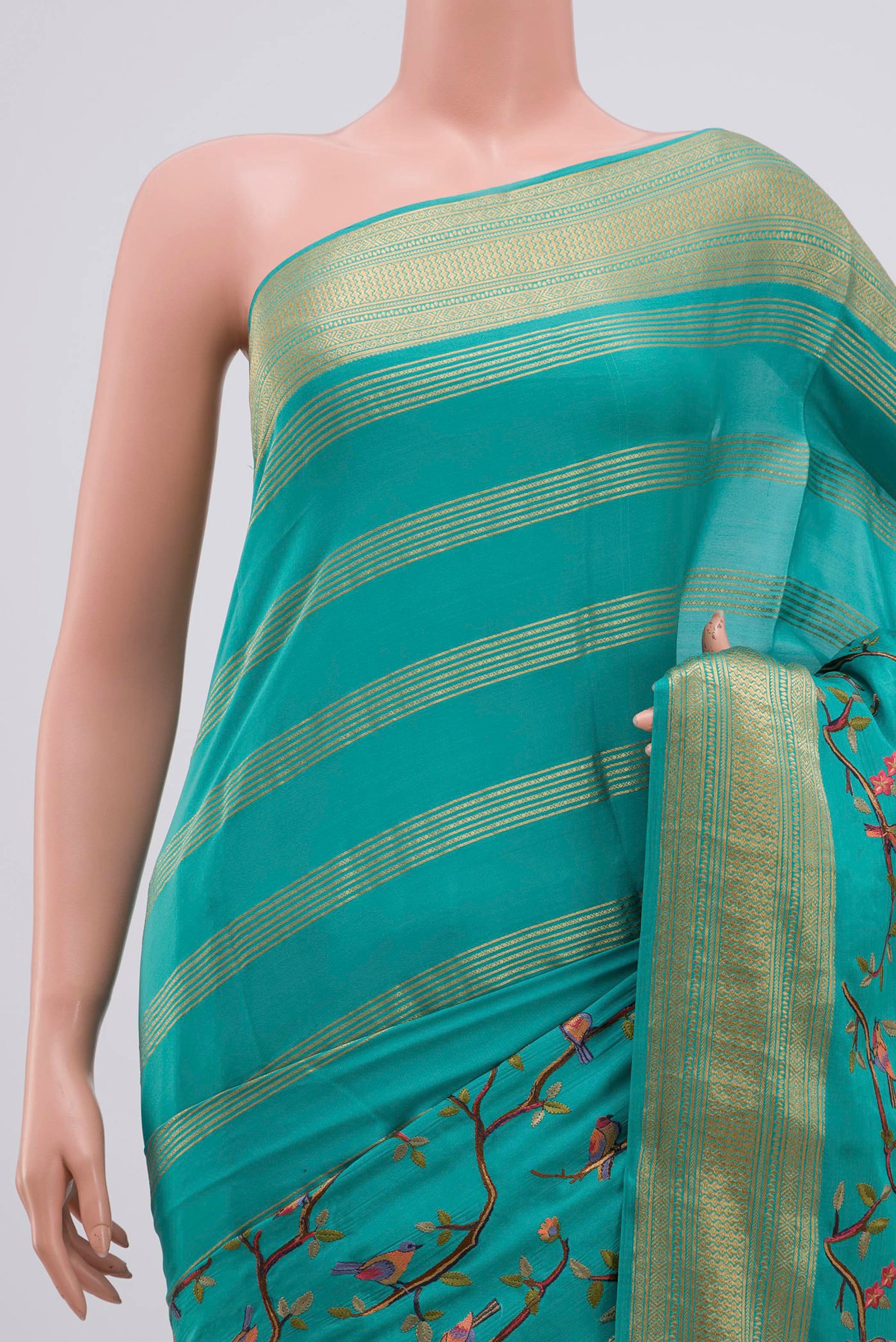 Border image of Blue Mysore Crepe Saree with Fancy on the body and Zari Border. 