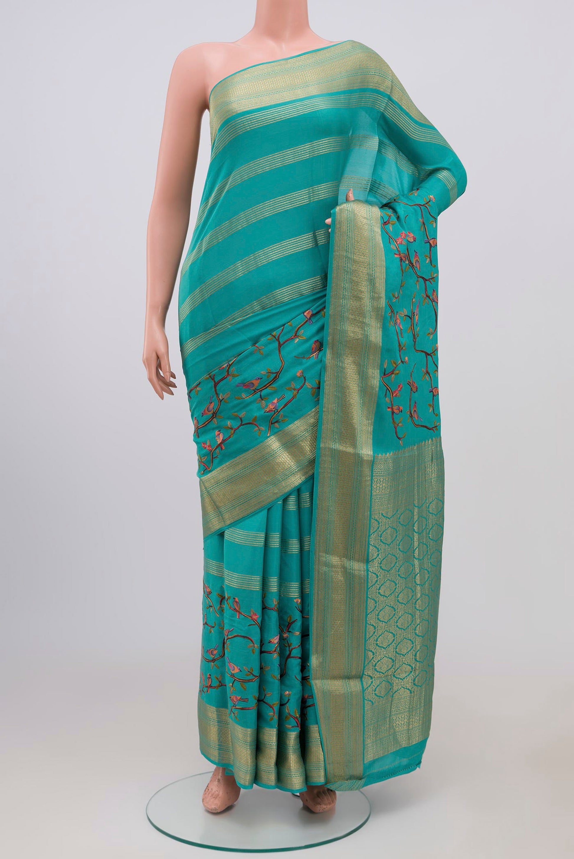 Blue Mysore Crepe Saree with Fancy on the body and Zari Border.  displayed on a mannequin