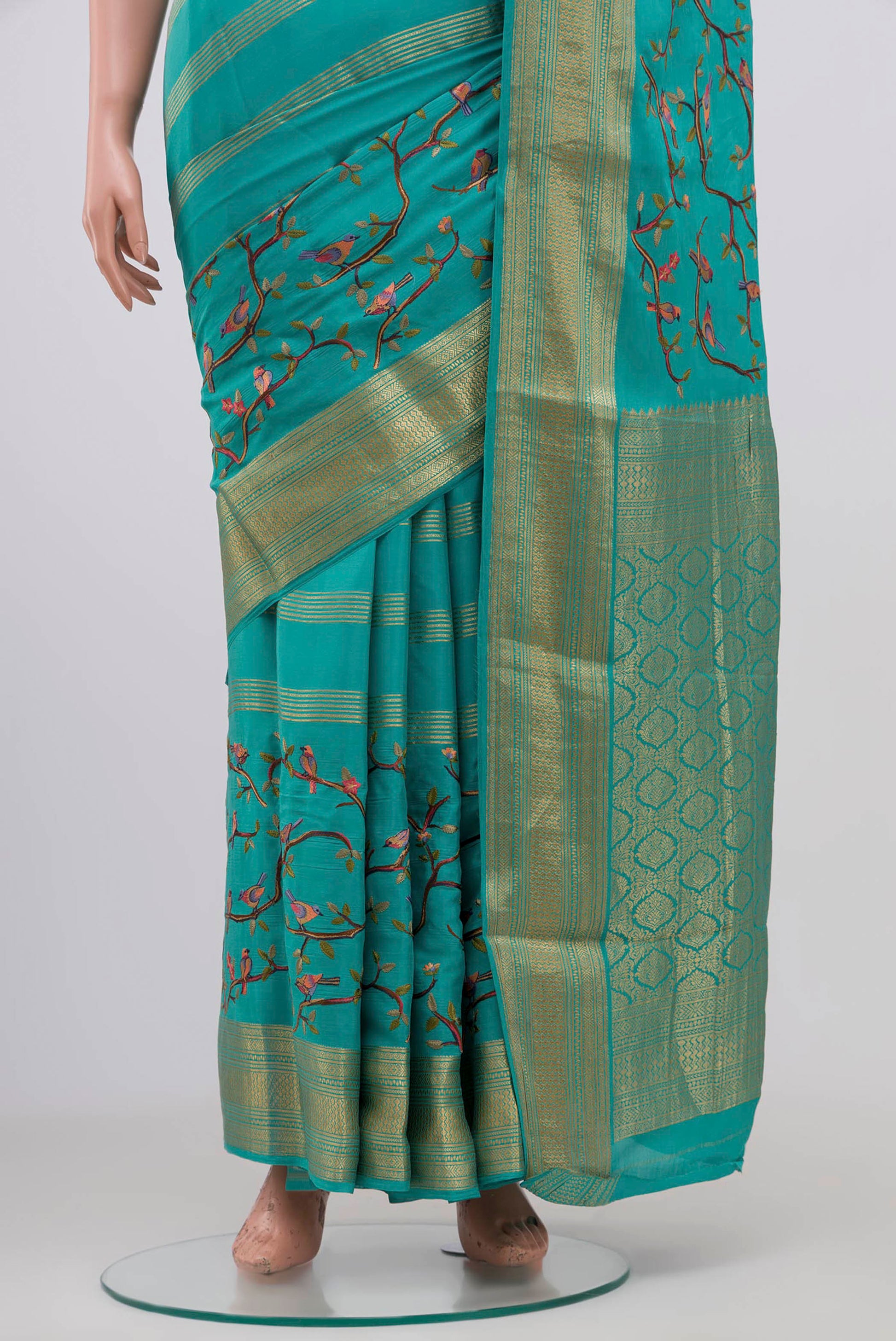 Pleats and pallu of Blue Mysore Crepe Saree with Fancy on the body and Zari Border. 