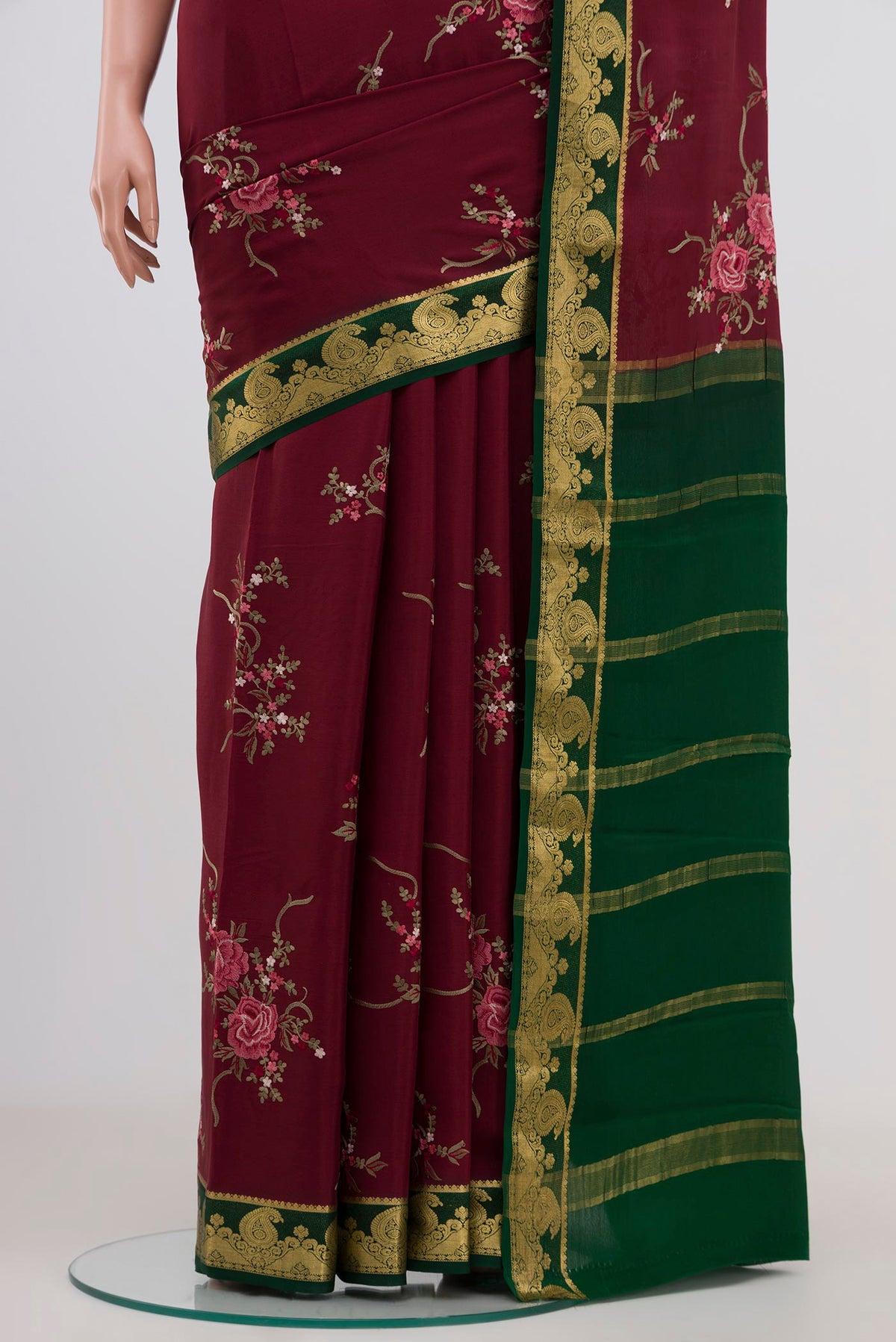 Pleats and pallu of Maroon Mysore Crepe Saree with Fancy on the body and Zari Border. 