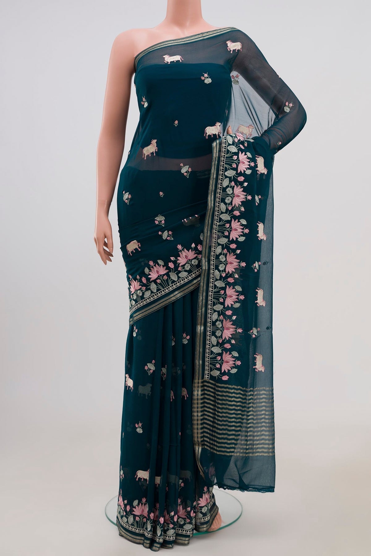 Blue Chiffon Saree with Embroidery on the body and Fancy Border.  displayed on a mannequin