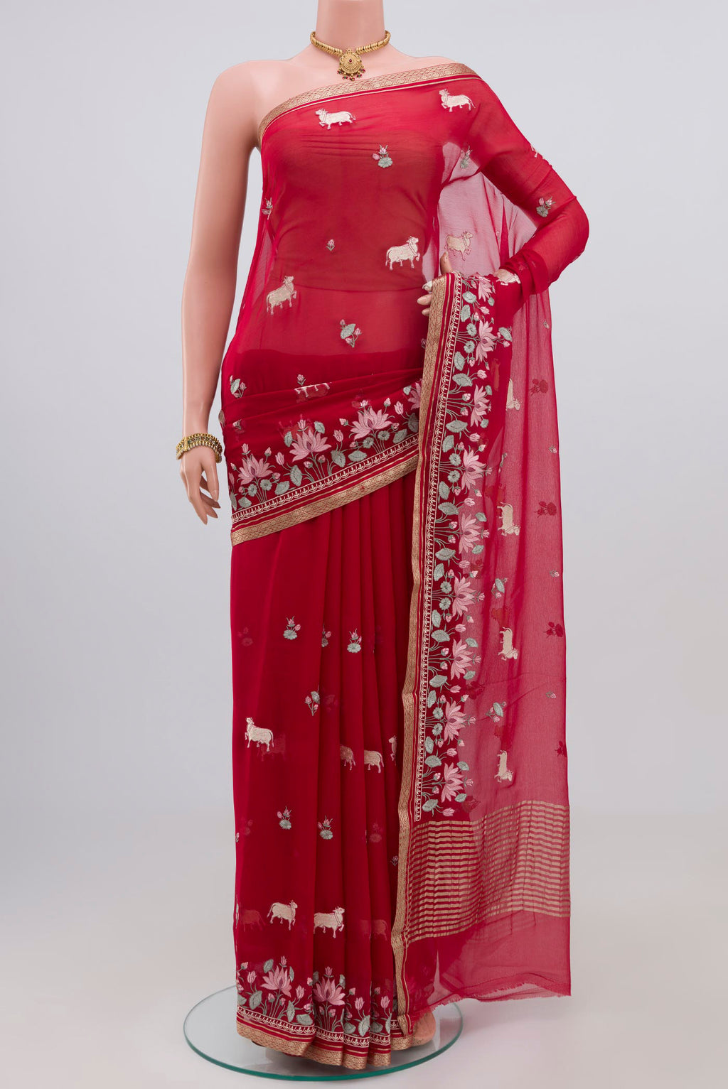Red Chiffon Saree with Fancy on the body and Zari Border.  displayed on a mannequin