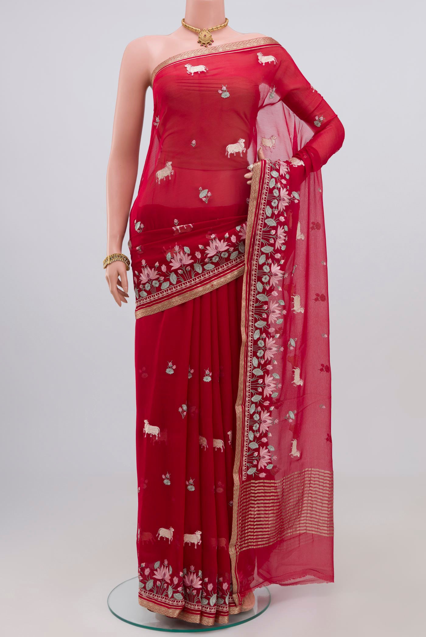 Red Chiffon Saree with Fancy on the body and Zari Border.  displayed on a mannequin