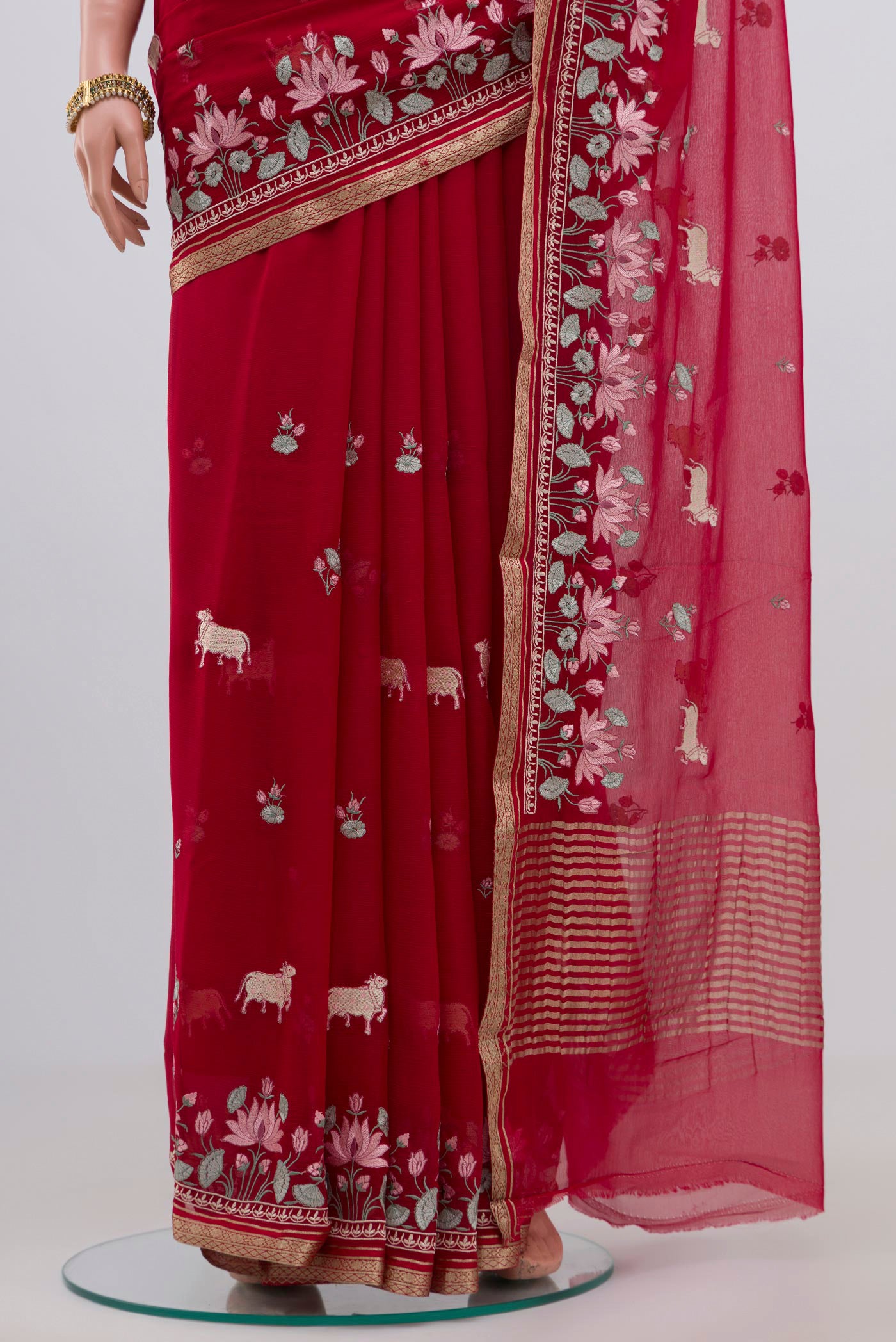 Pleats and pallu of Red Chiffon Saree with Fancy on the body and Zari Border. 