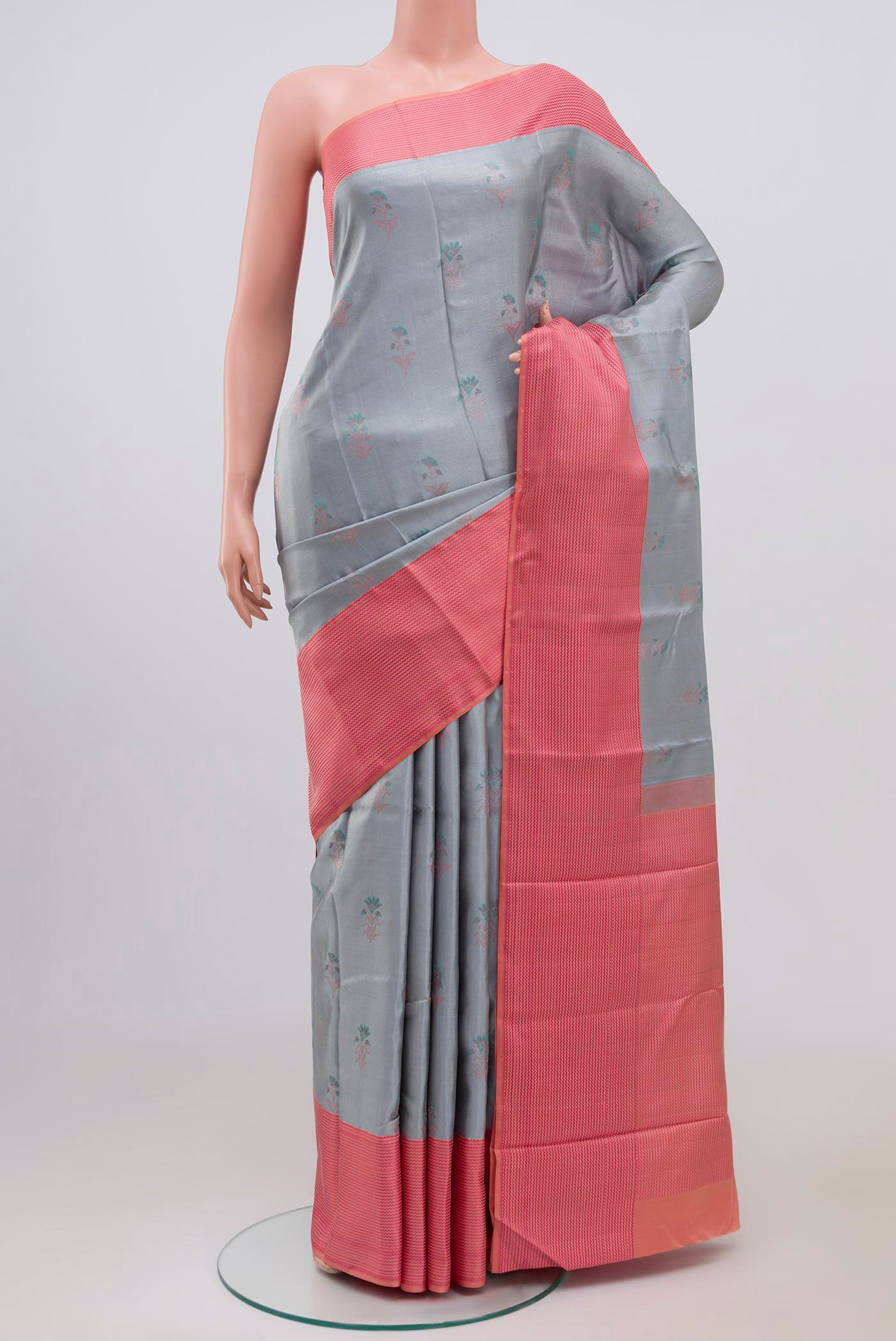 Grey Kanchipuram Silk Saree with Zari Butta on the body and Thin Zari Line.  displayed on a mannequin