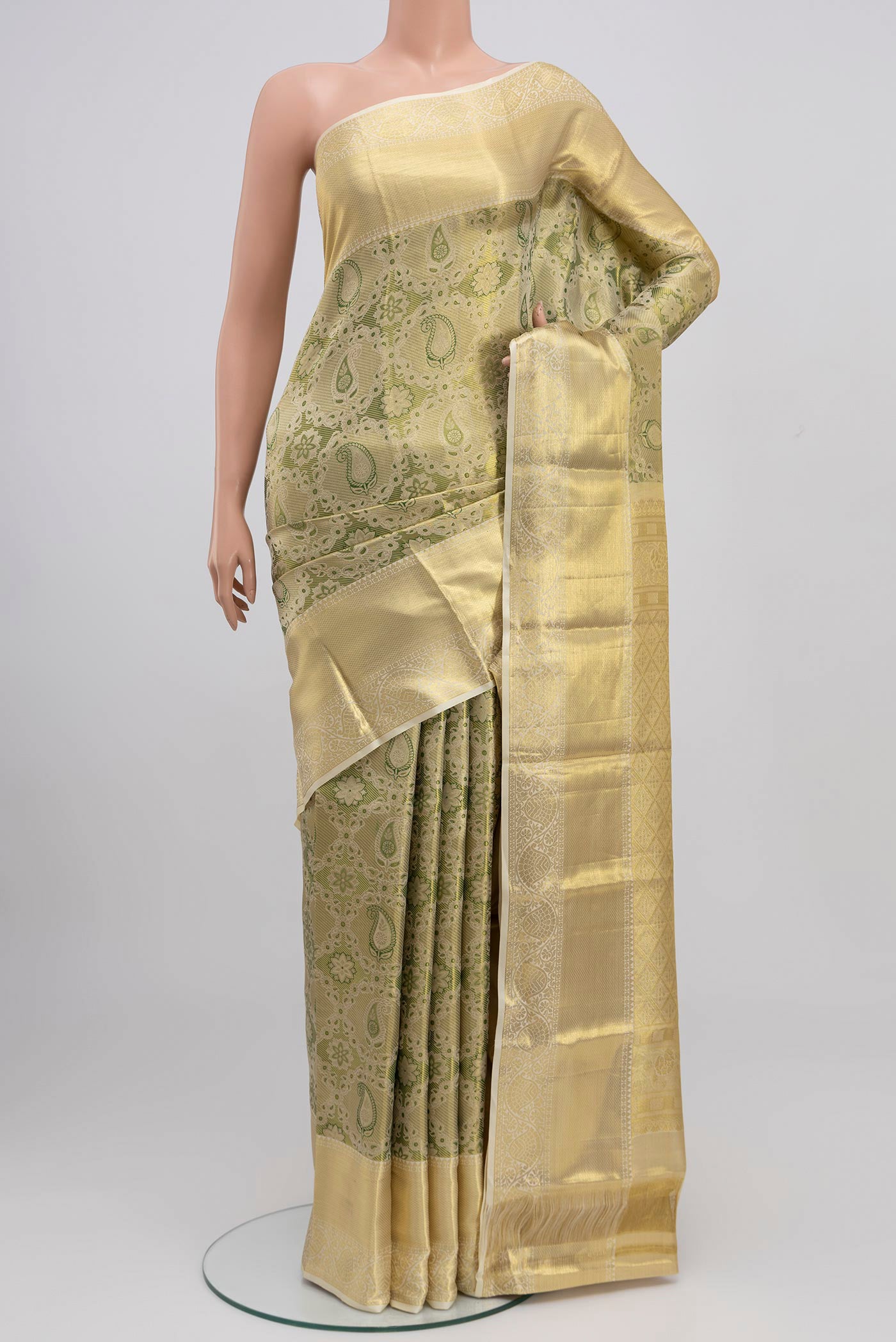 Green Kanchipuram Saree with Zari Brocade on the body and Zari Border.  displayed on a mannequin