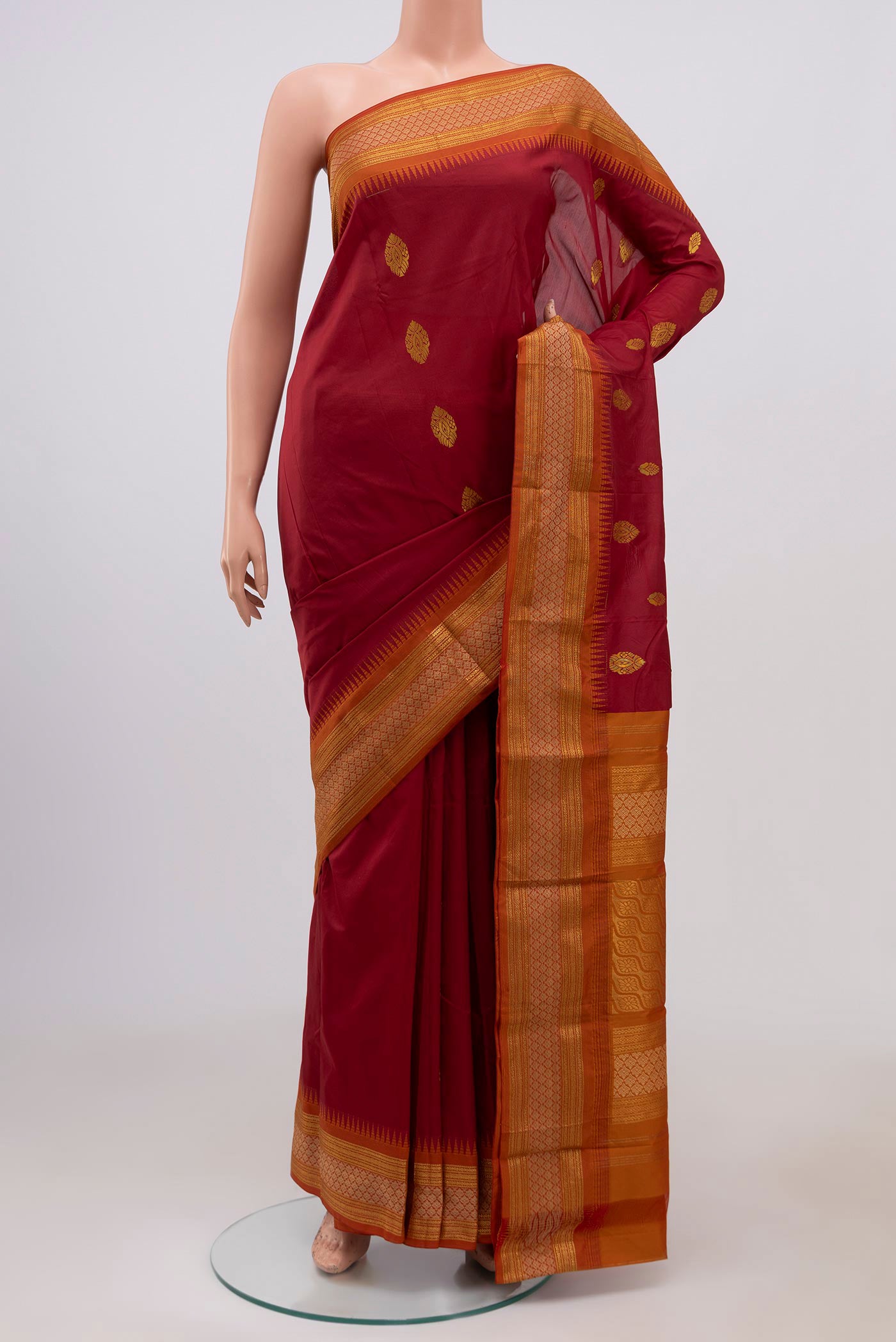Maroon Blended Bangalore Silk Saree with Zari Butta on the body and Zari Border.  displayed on a mannequin