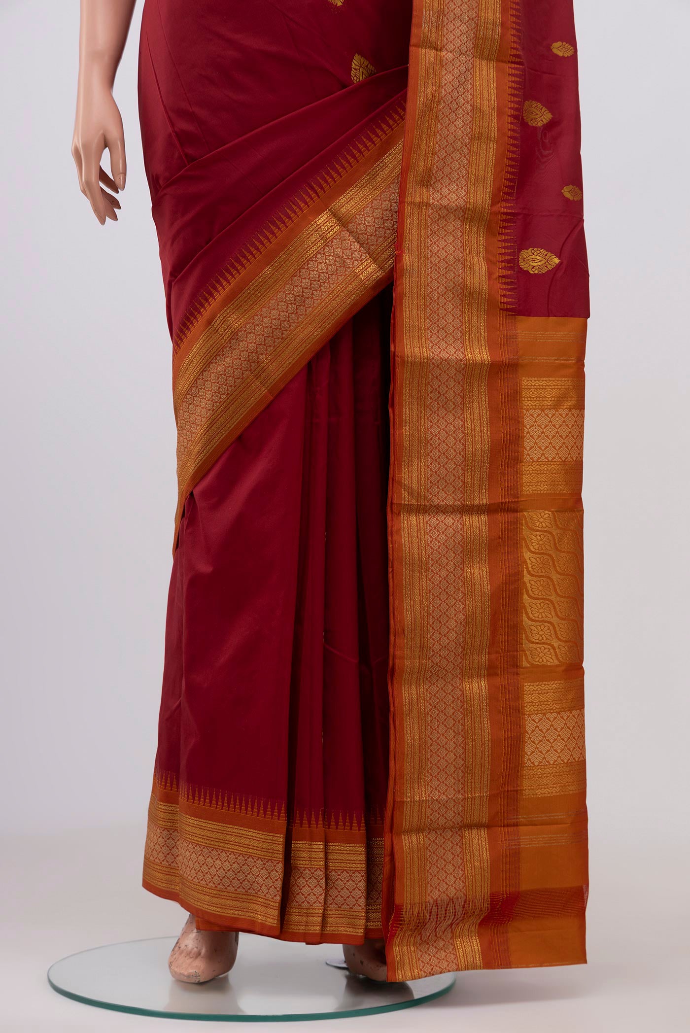 Pleats and pallu of Maroon Blended Bangalore Silk Saree with Zari Butta on the body and Zari Border. 
