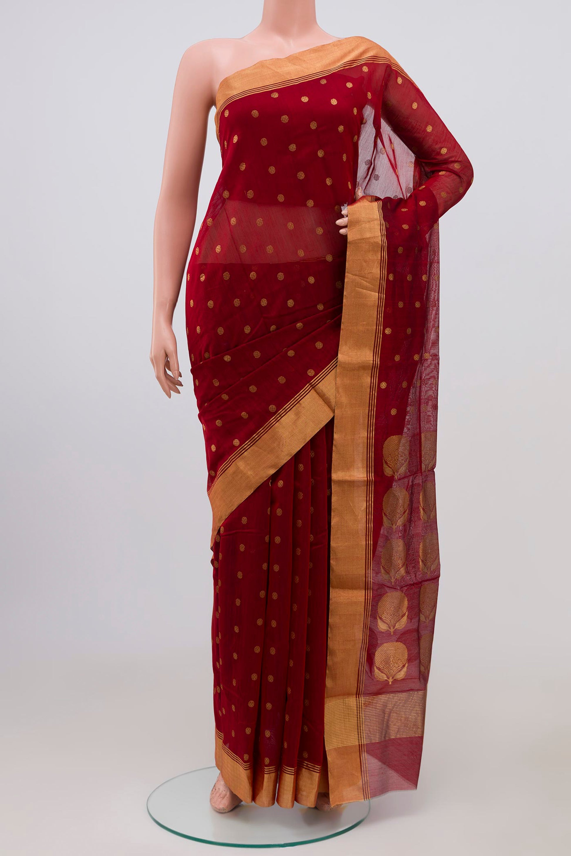 Maroon Chanderi Silk Cotton Saree with Zari Butta on the body and Zari Border.  displayed on a mannequin