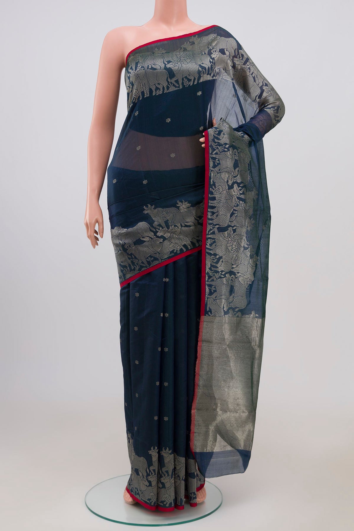 Navy Blue Chanderi Silk Cotton Saree with Zari Butta on the body and Fancy Border.  displayed on a mannequin