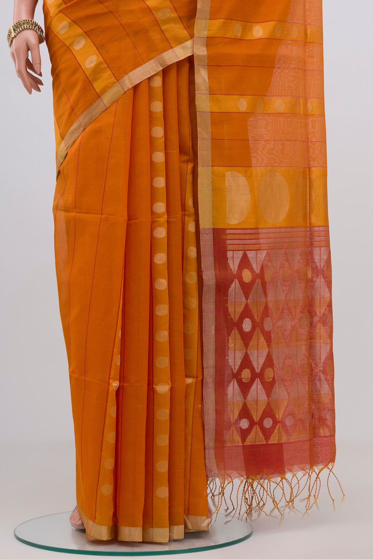 Pleats and pallu of Orange Silk Cotton Saree with Zari Butta on the body and Thin Zari Line. 
