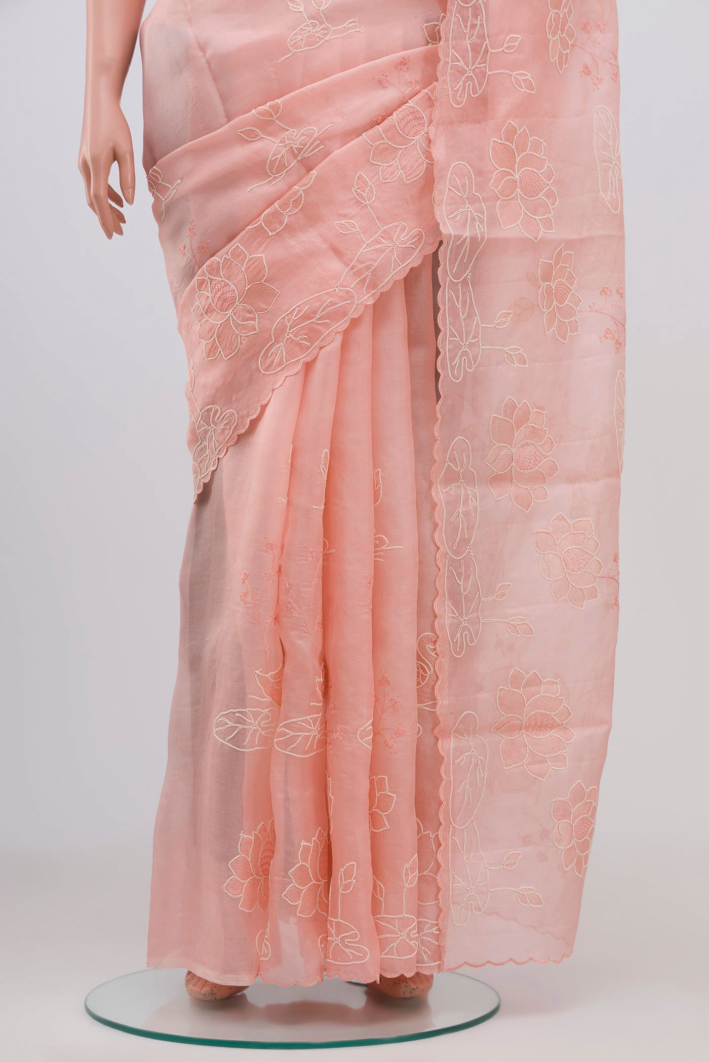 Pleats and pallu of Peach Organza Silk Saree with Fancy on the body and Without Border. 