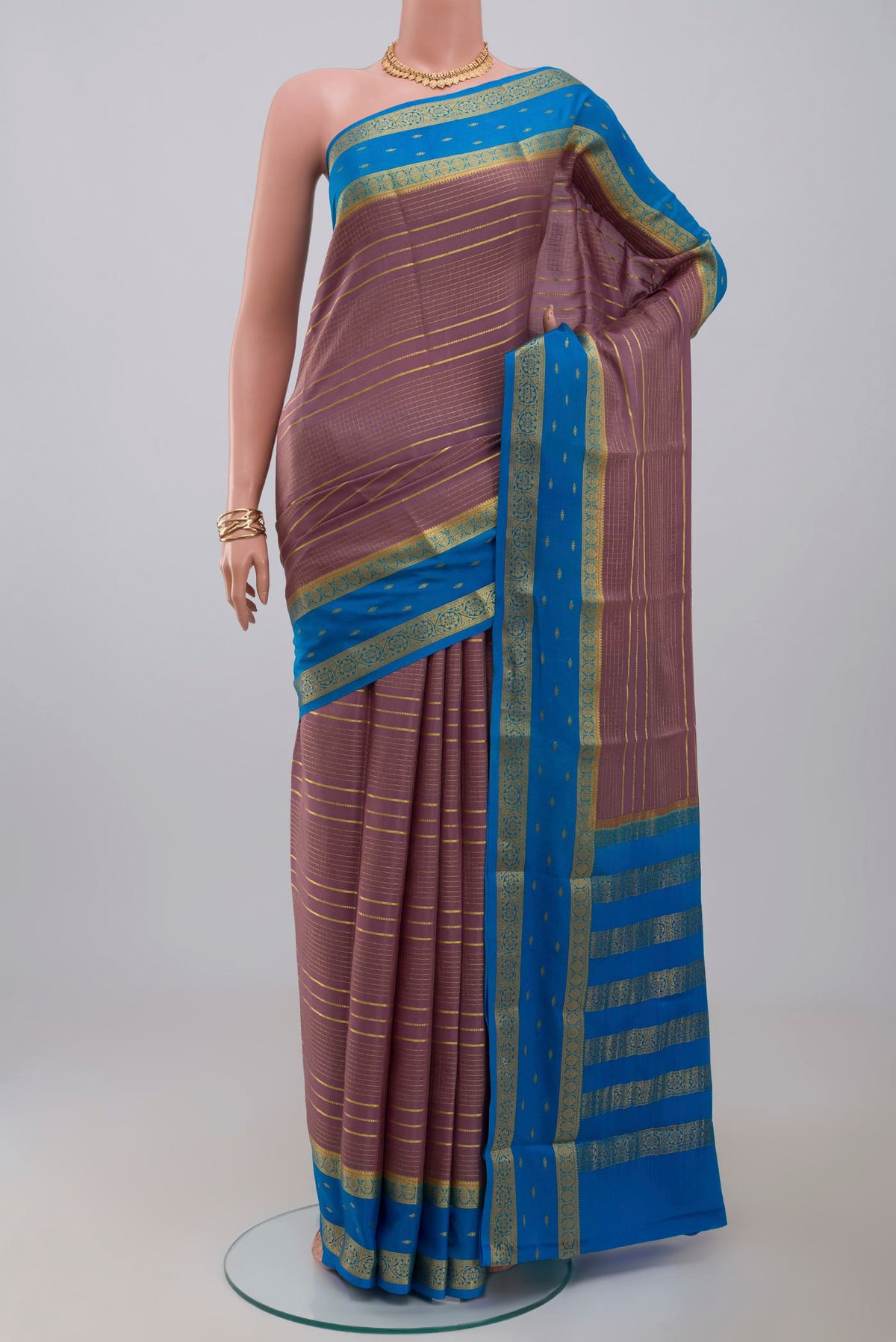 Lavender Crepe Saree with Checked design on the body and Zari Border.  displayed on a mannequin
